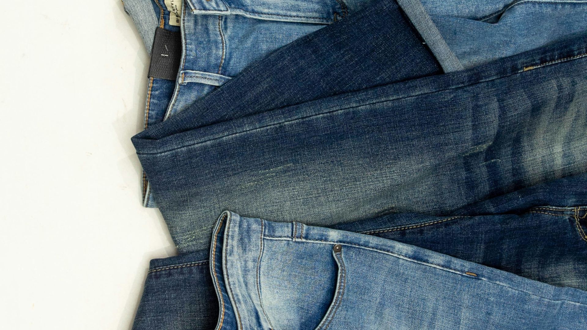 A pile of jeans laying on top of each other