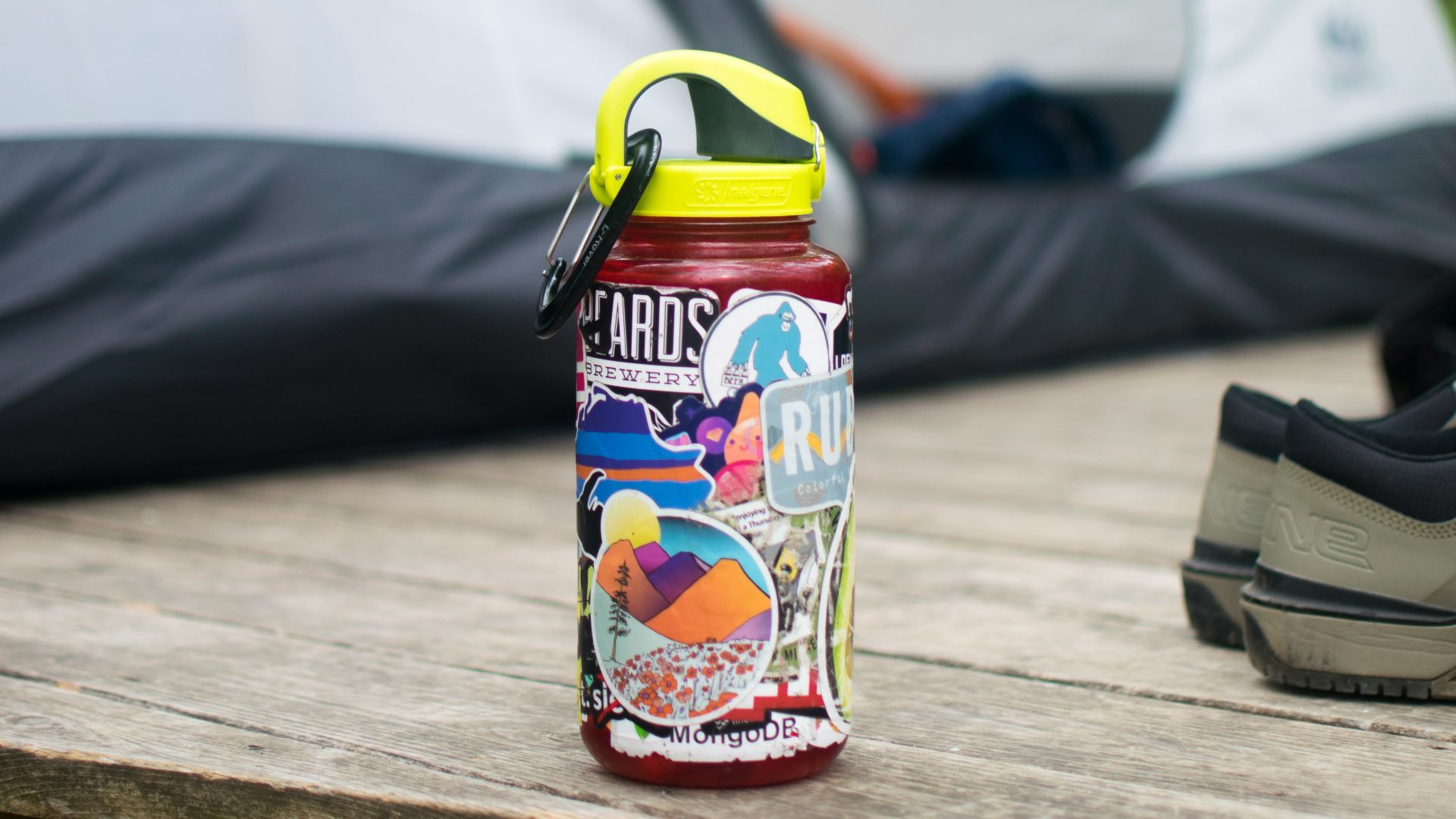 a bottle of water sitting on a table next to a tent
