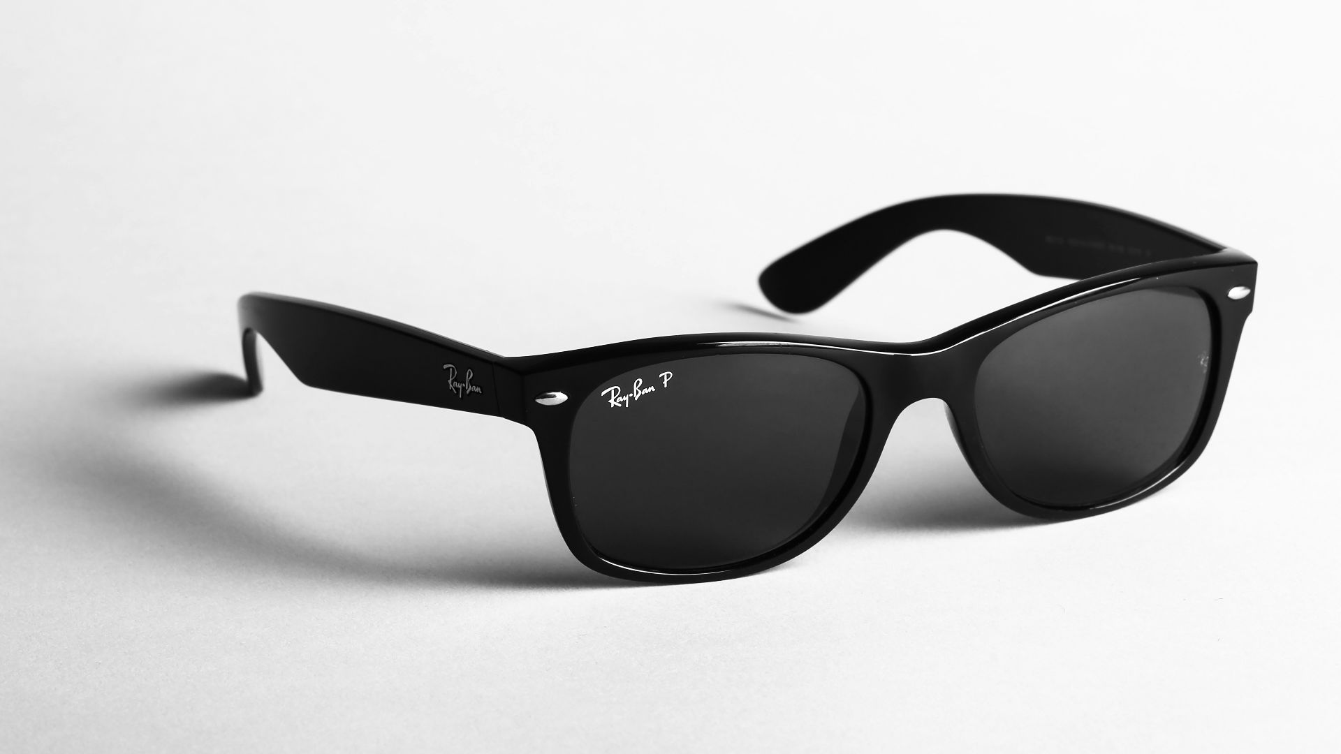 shallow focus photo of black Ray-Ban wayfarer sunglasses