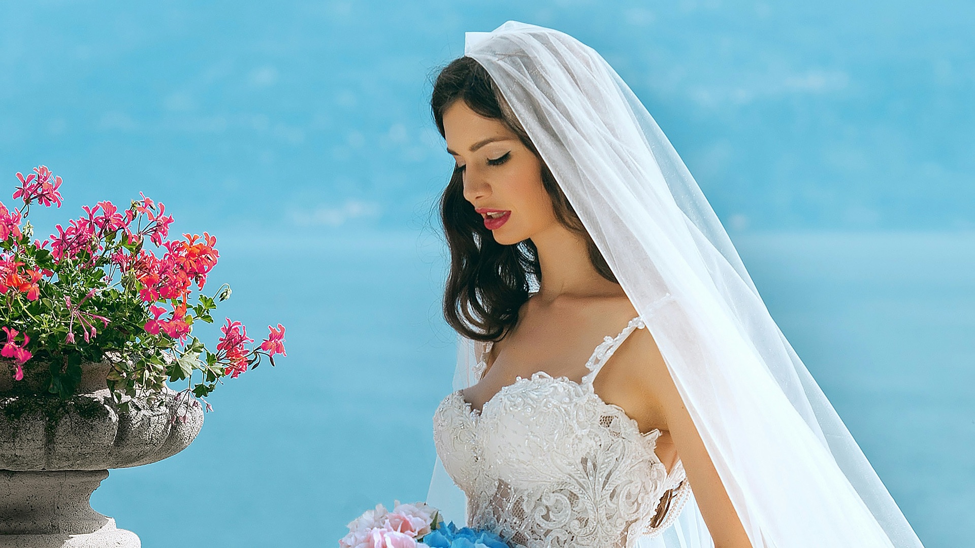 woman in wedding dress while holding flower during daytime