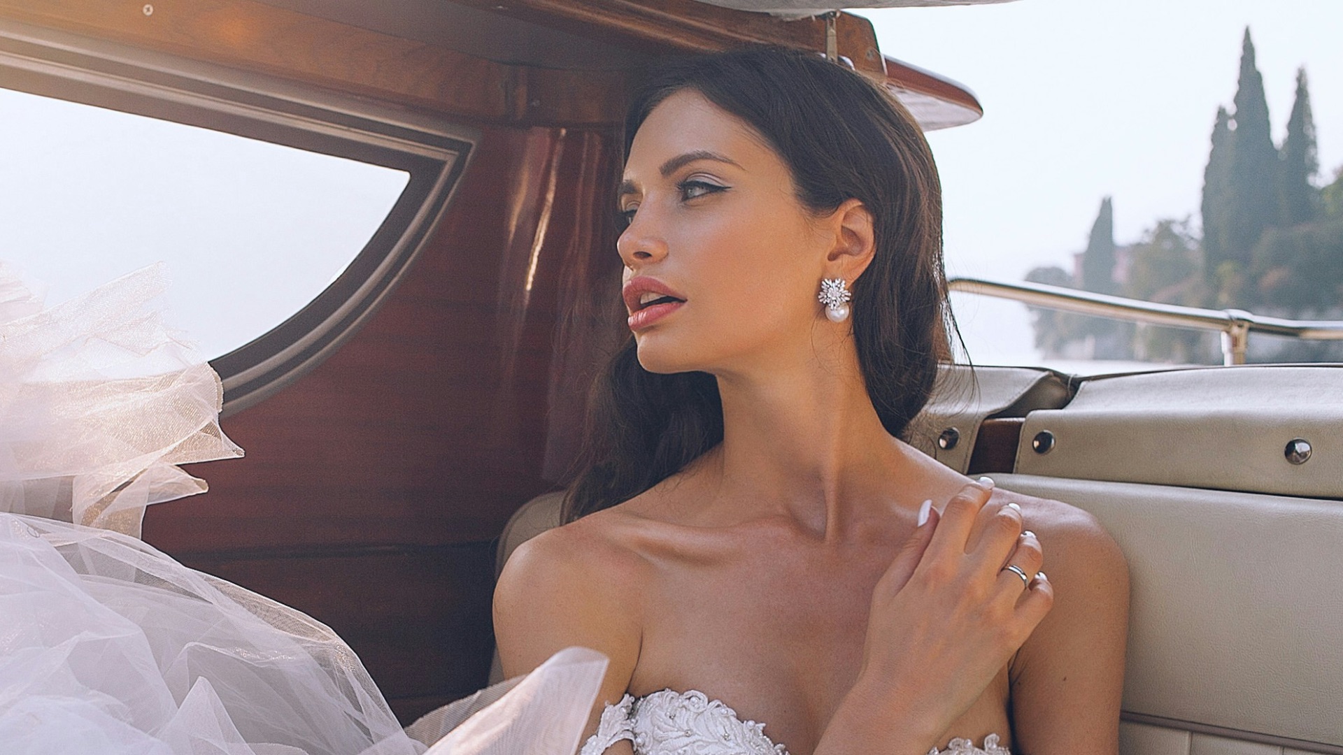 woman wearing white sweetheart-neckline wedding dress inside vehicle