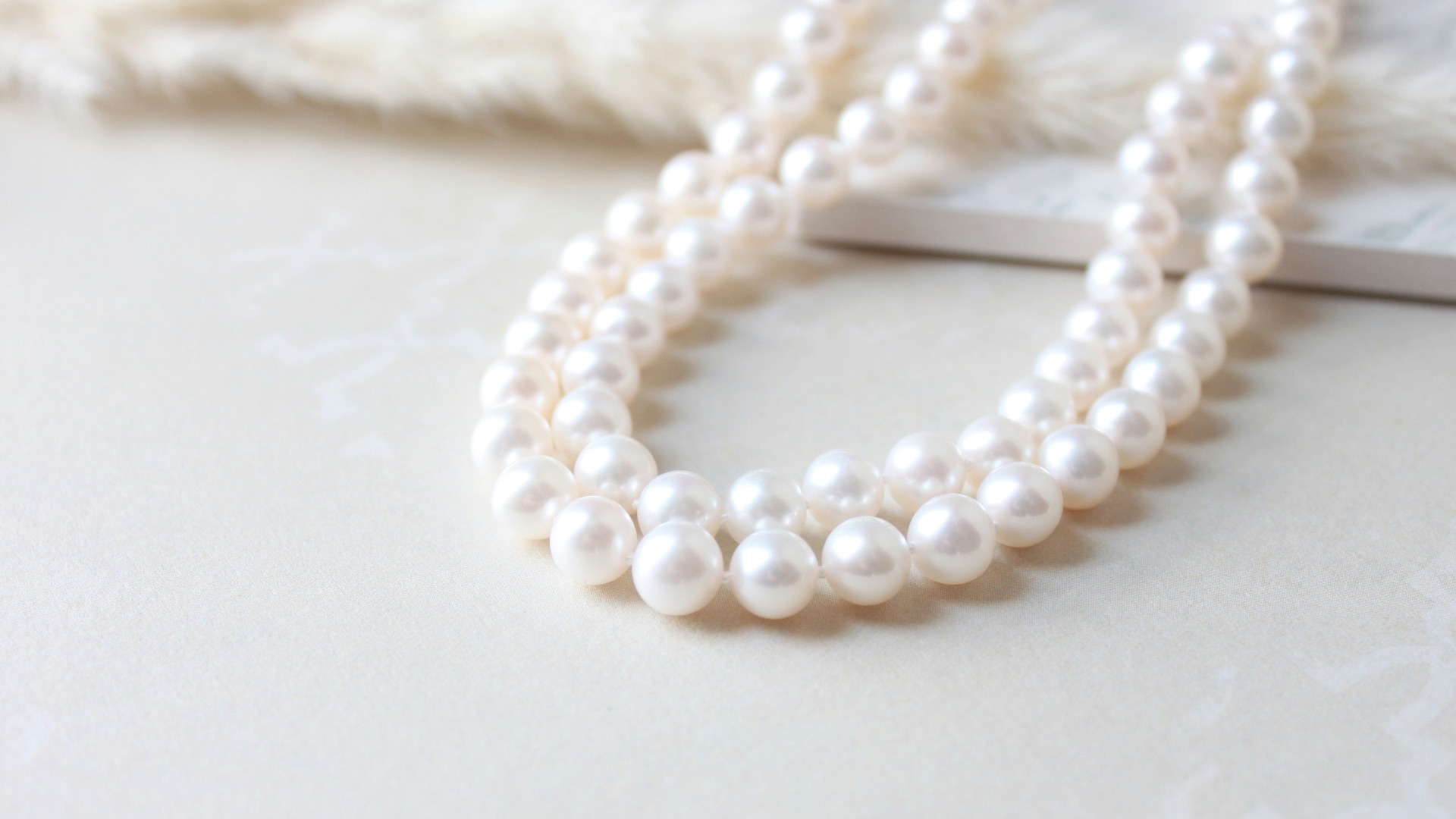 a close up of a necklace with pearls