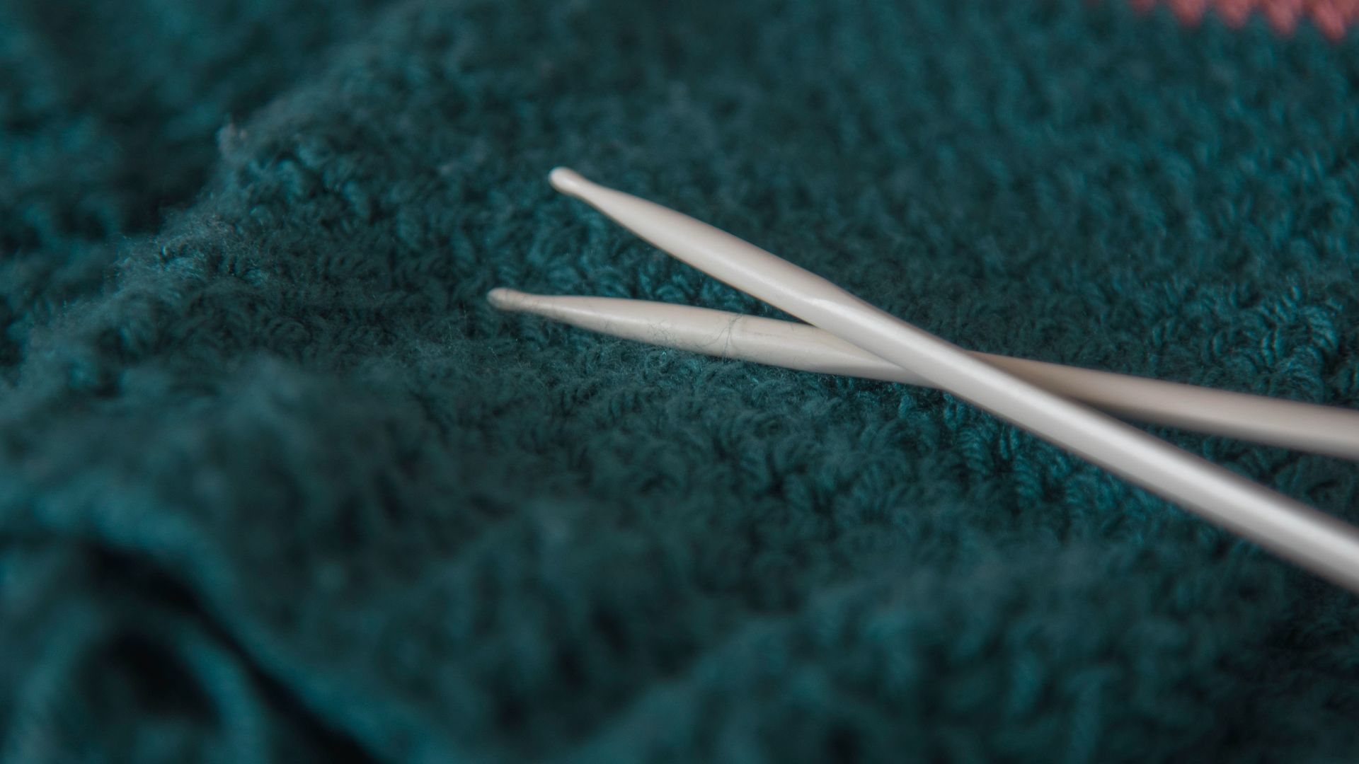 white coated wire on green and red textile
