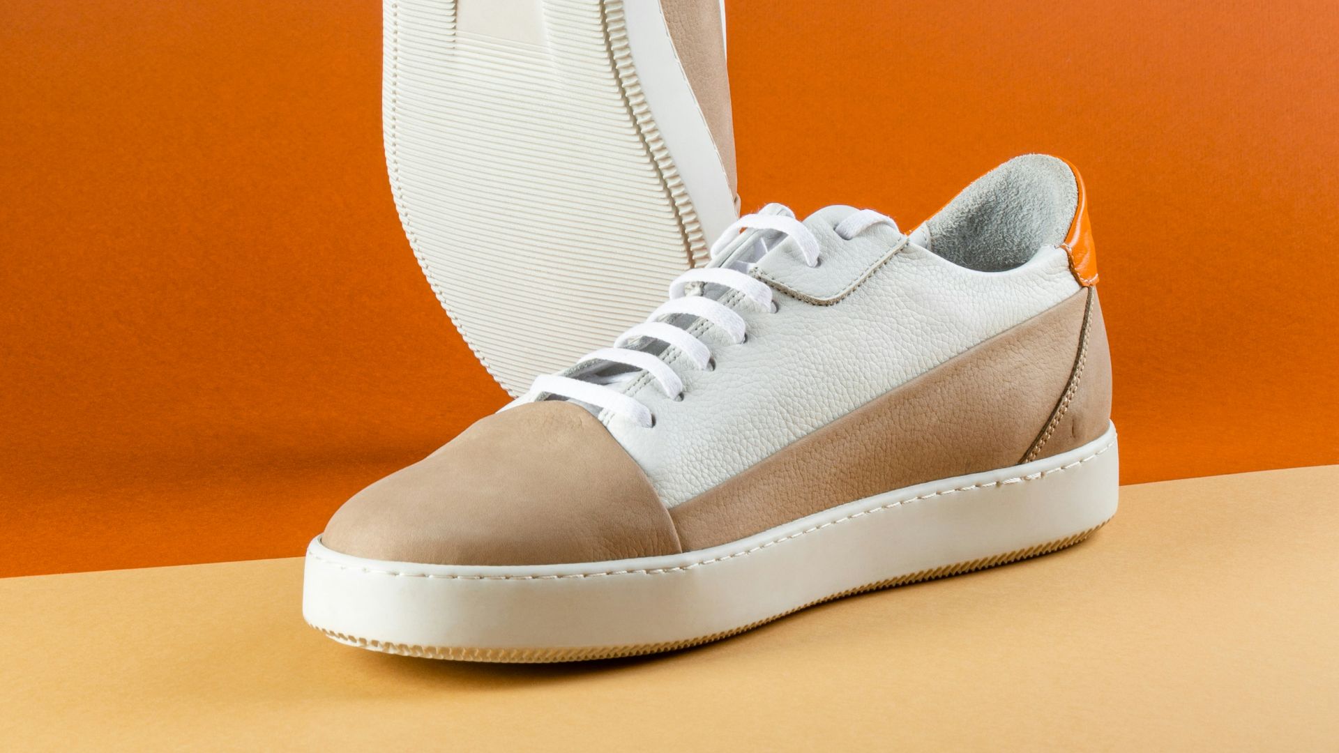 a pair of white and brown shoes on a table