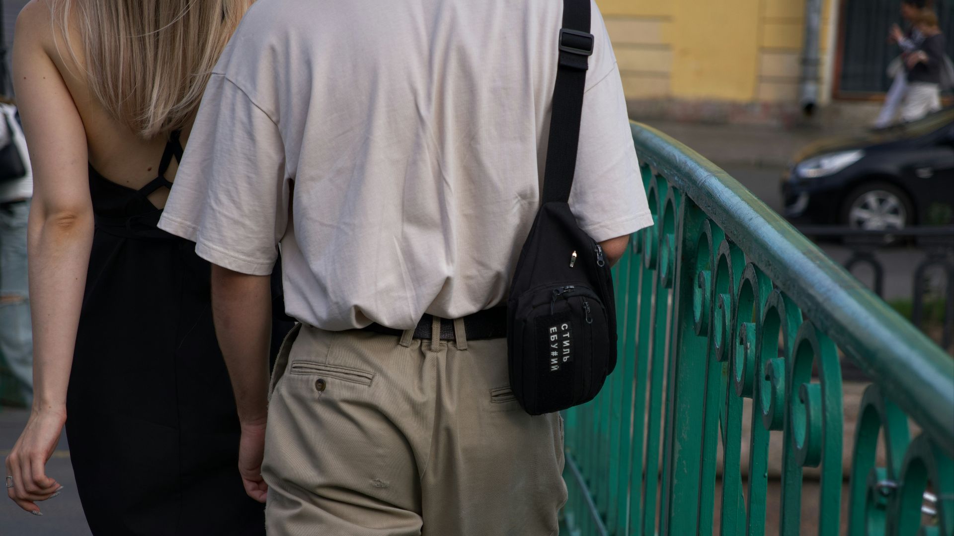 A man and a woman walking down a street