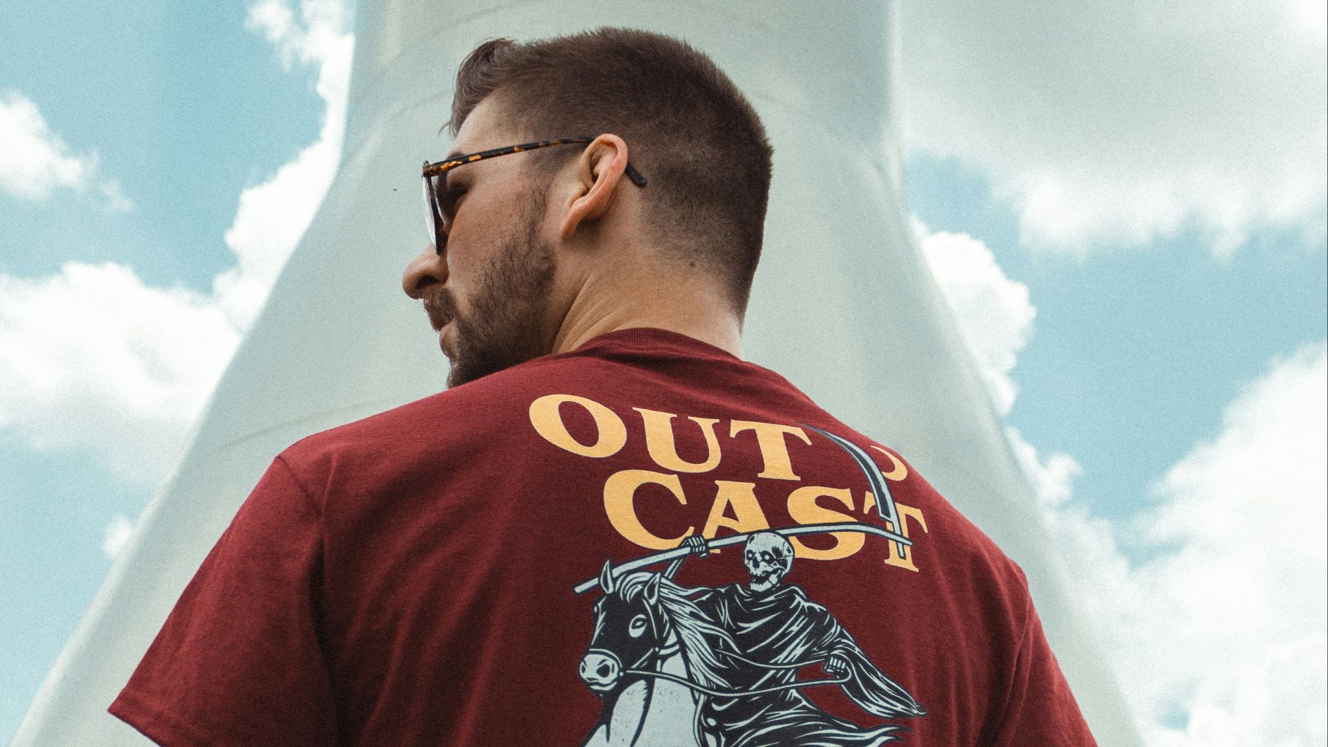 man standing beside white concrete monument