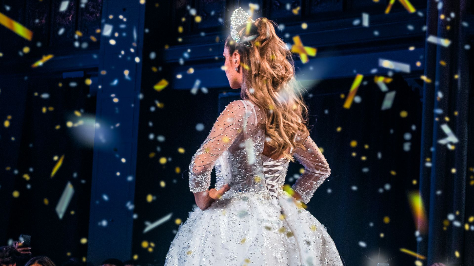 woman in white dress standing on stage