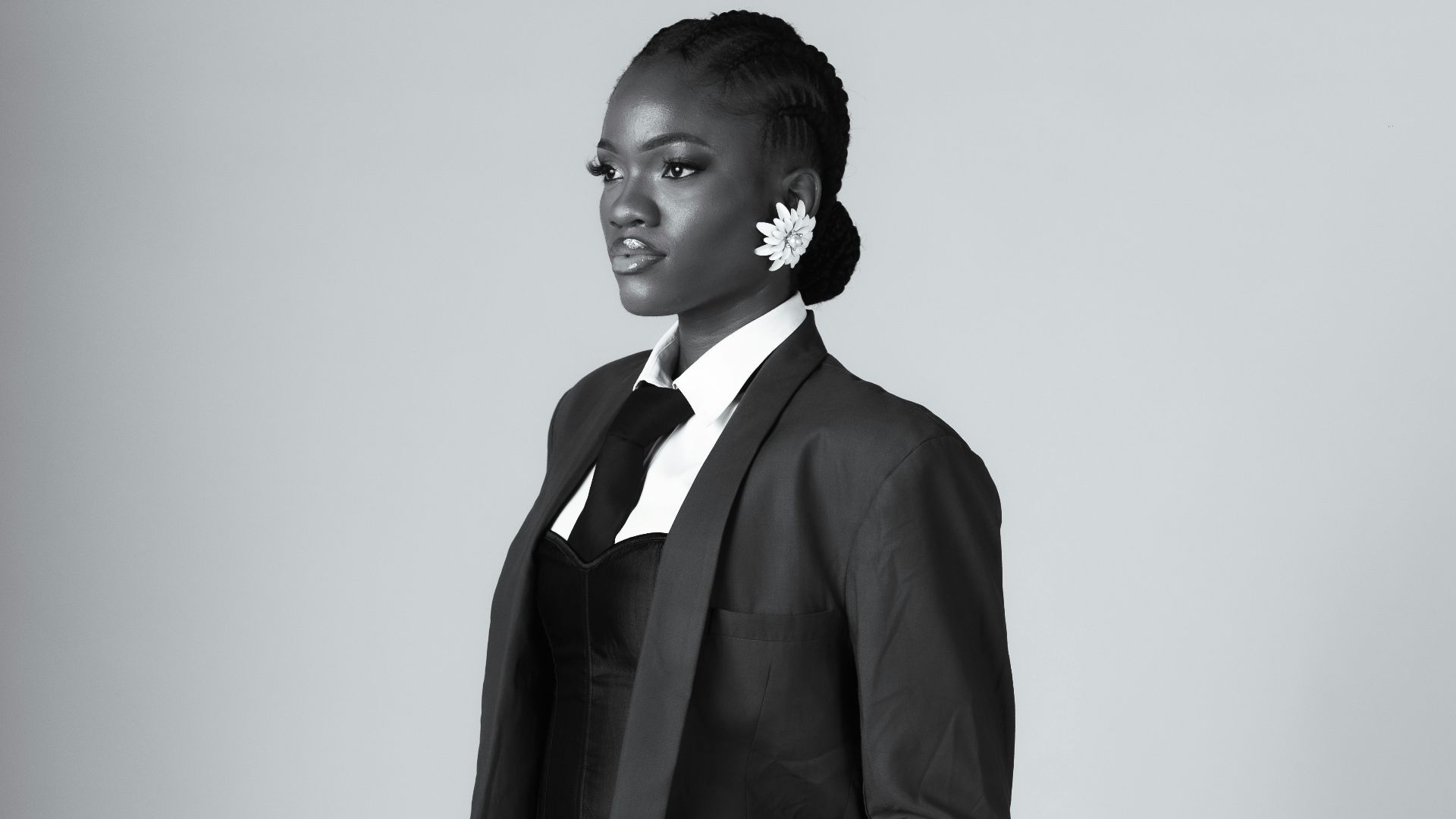 Woman in a suit with hands in pockets