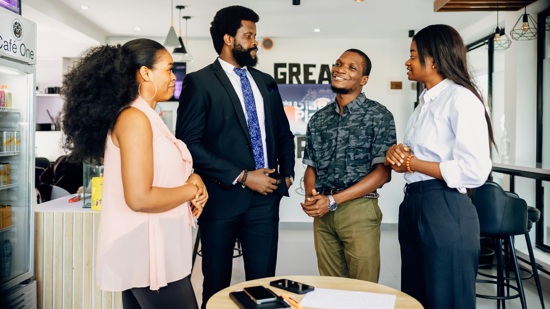A group of people standing around a table