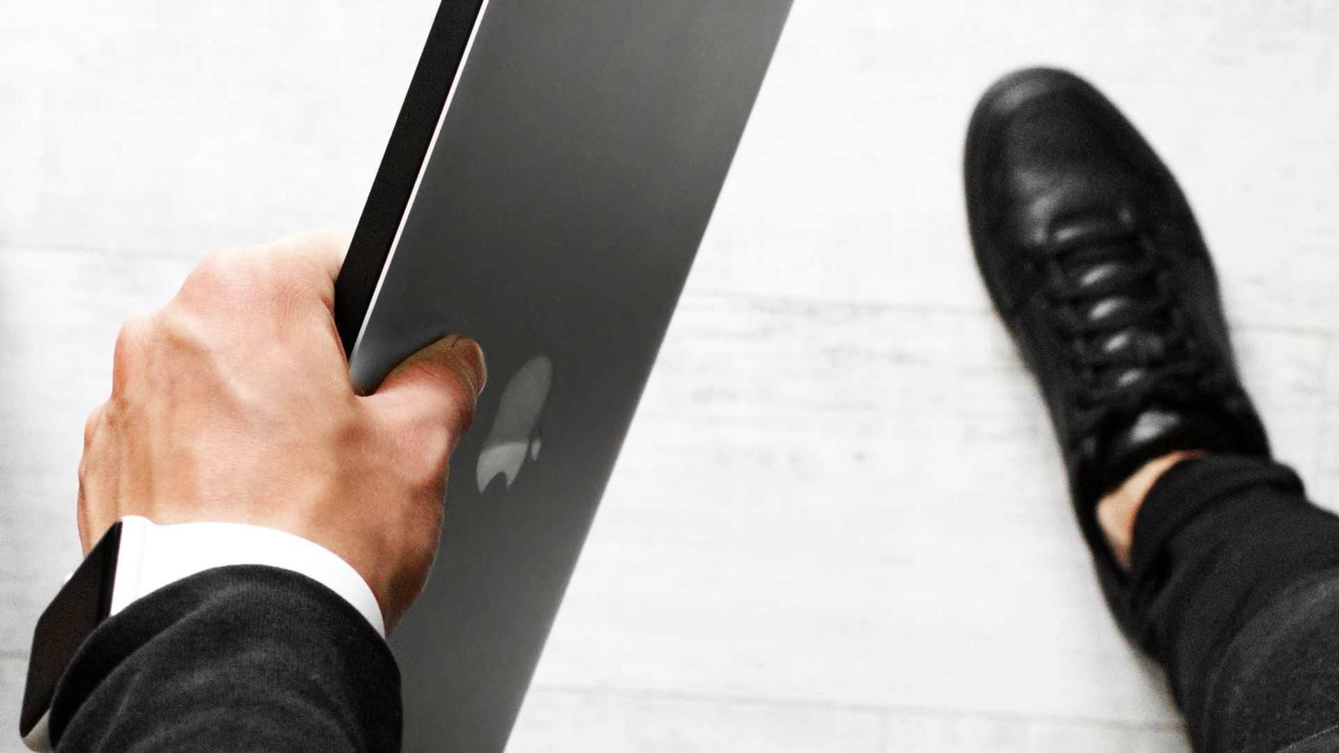 person in black pants and black leather shoes