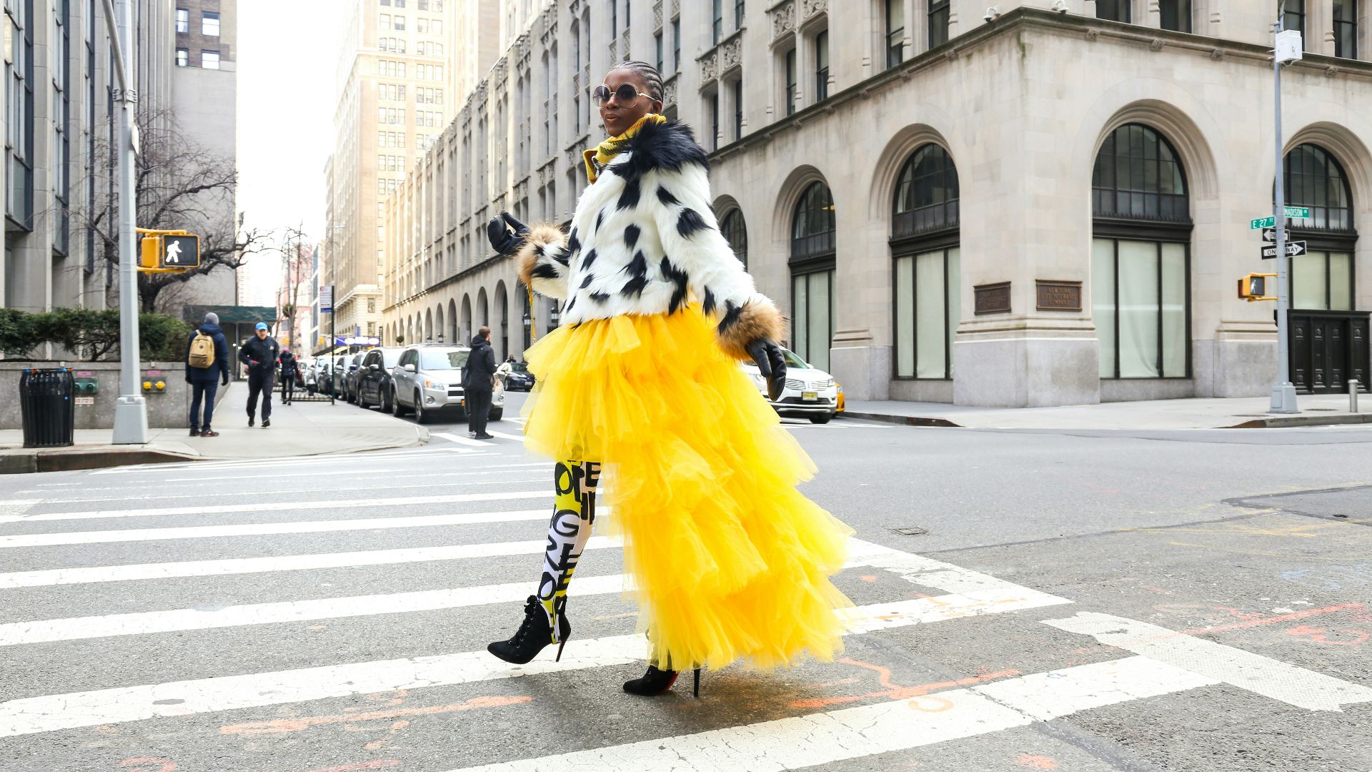 woman wearing yellow and white dress passing on road