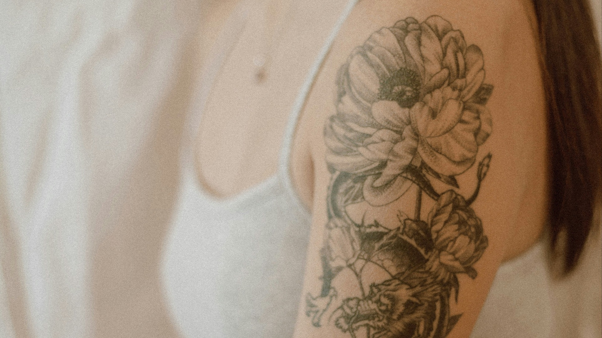 woman with black and red rose tattoo on her right arm