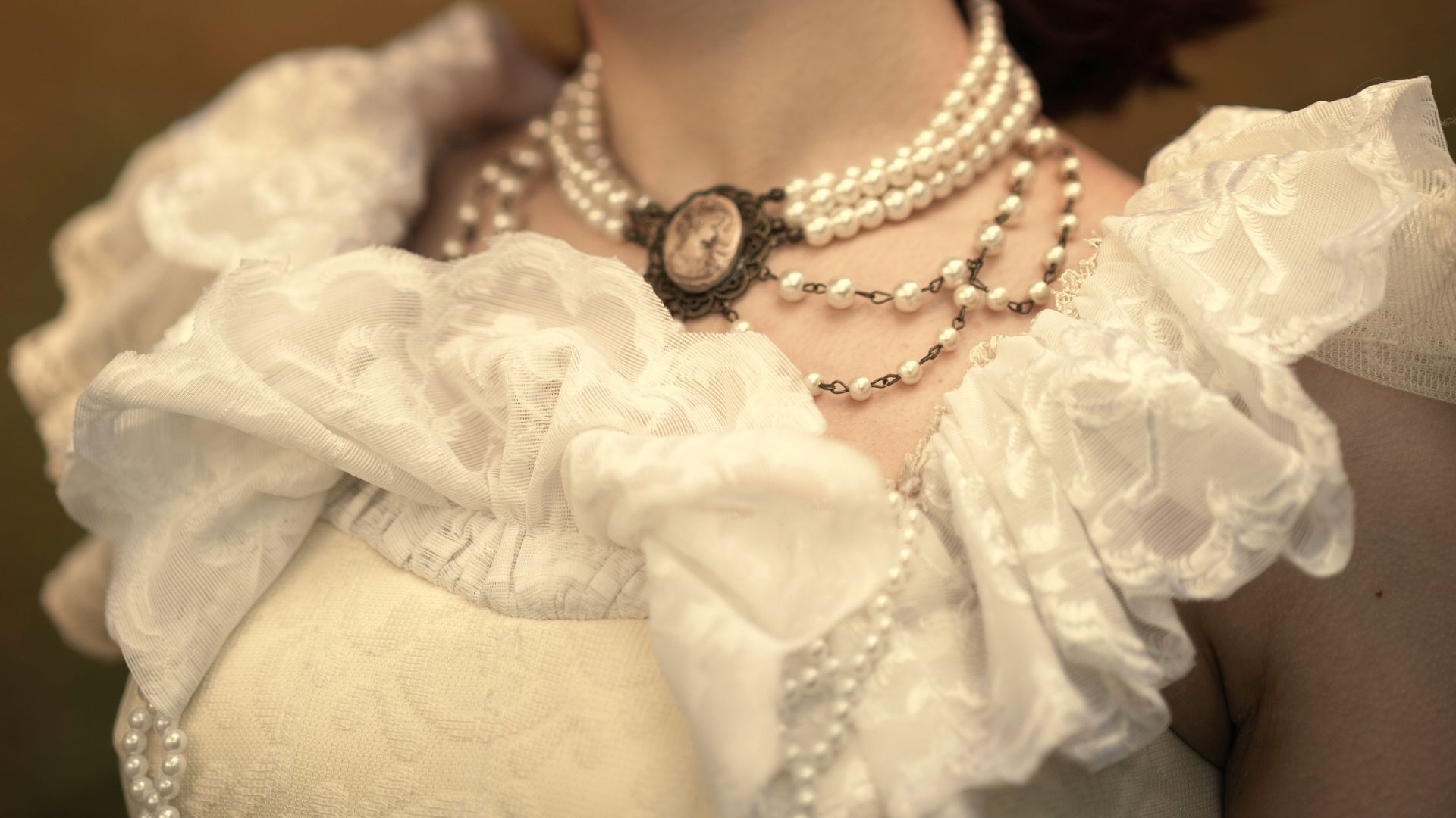 Young woman in vintage dress with pearls