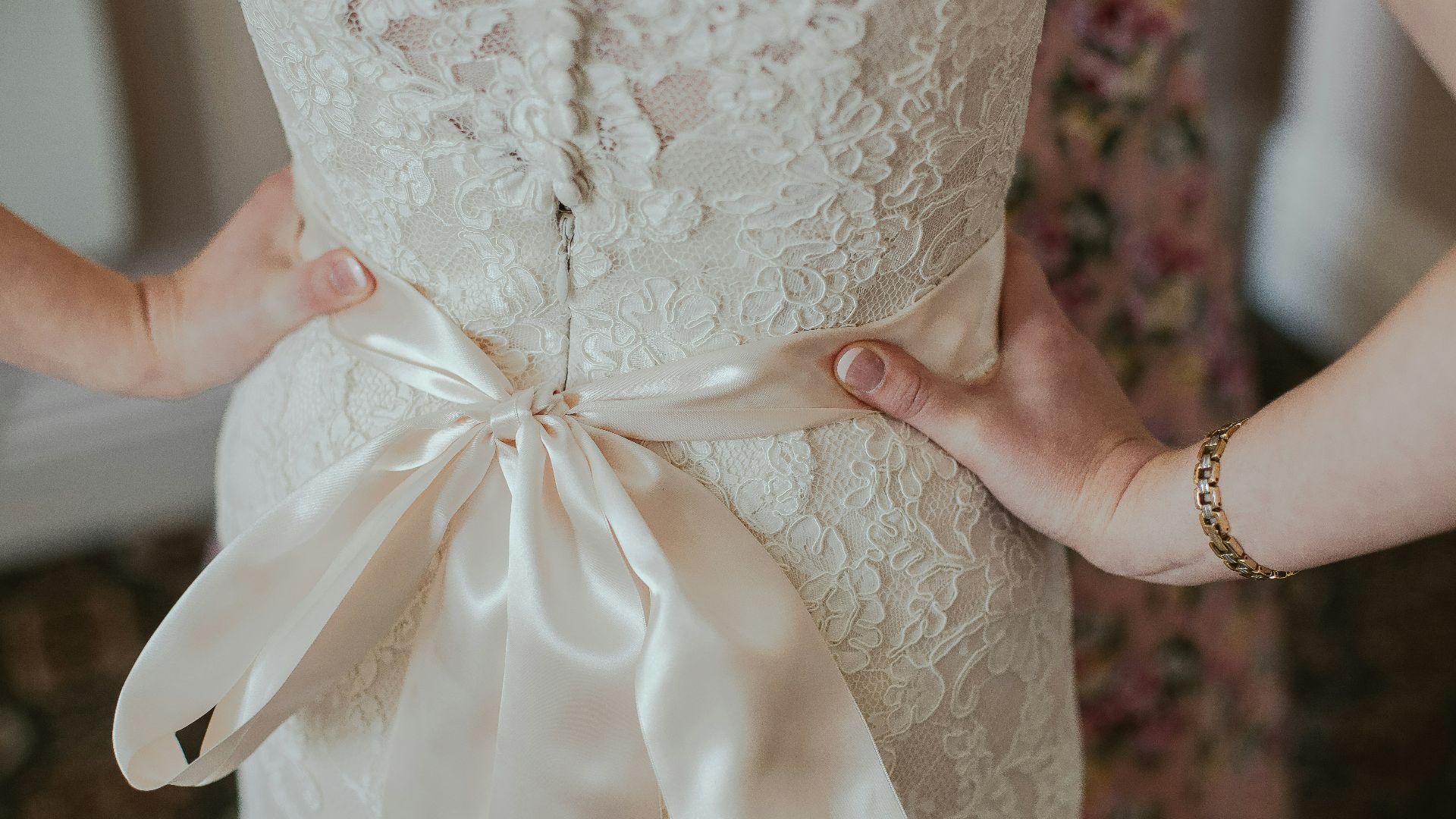 woman wearing beige lace gown with bow belt