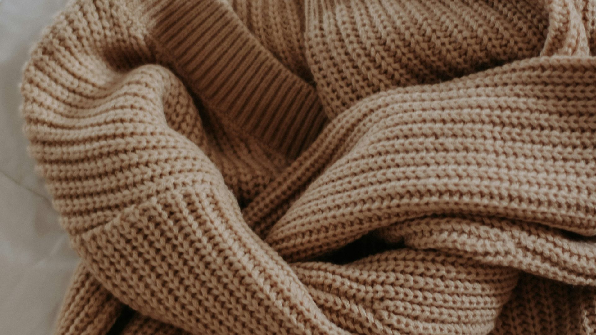 a brown towel on a white surface