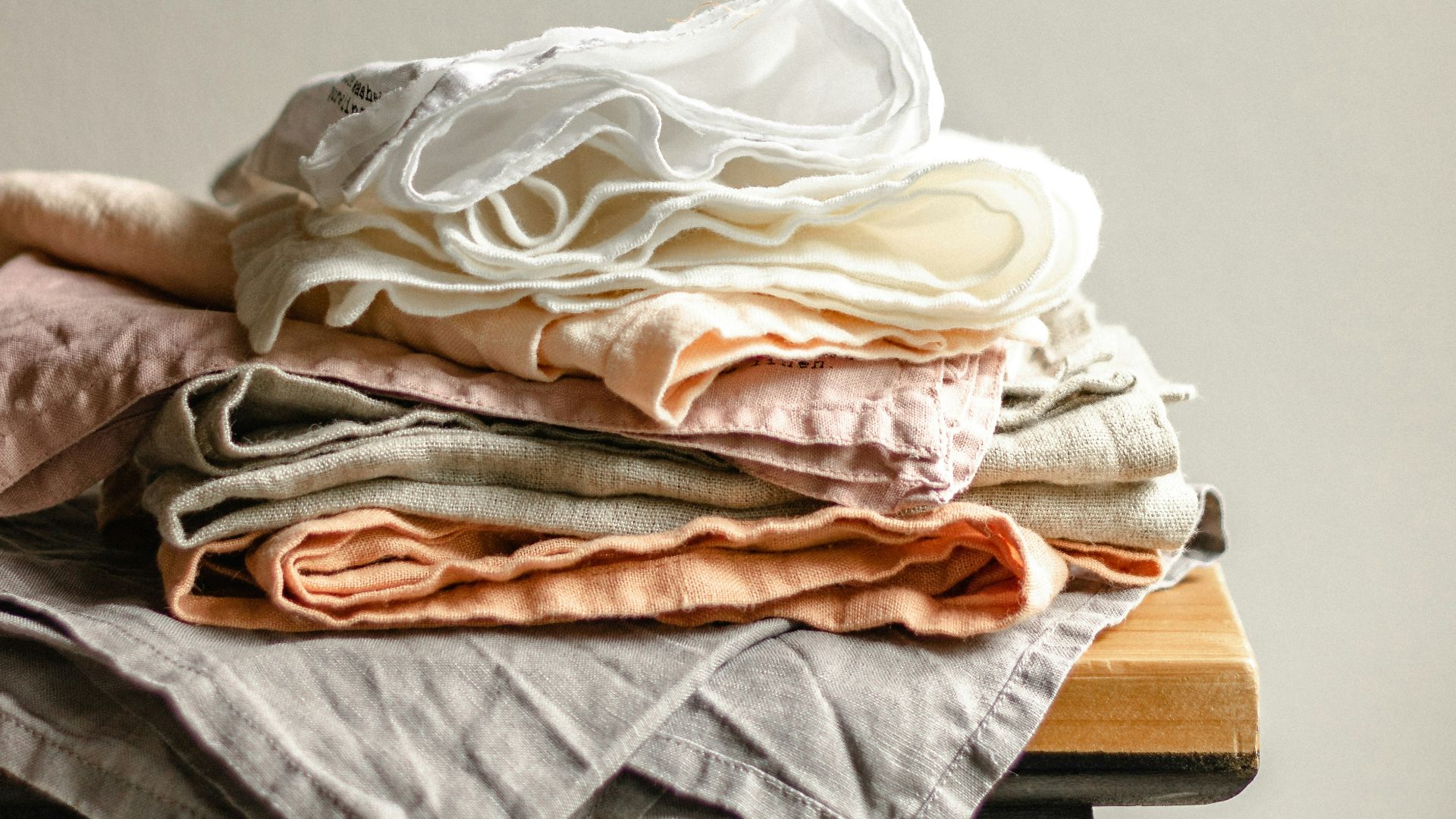 white textile on brown wooden table
