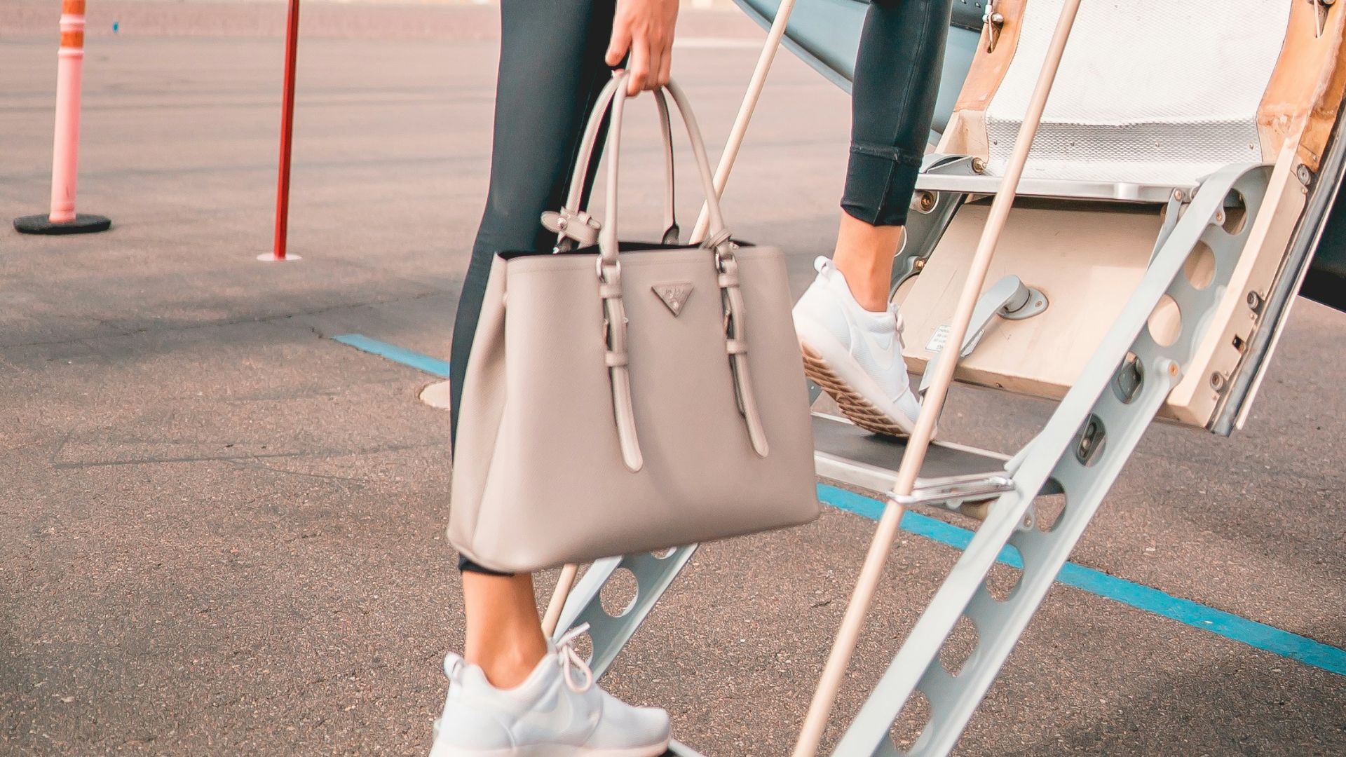 woman in black lingerie sitting on white and red boat during daytime