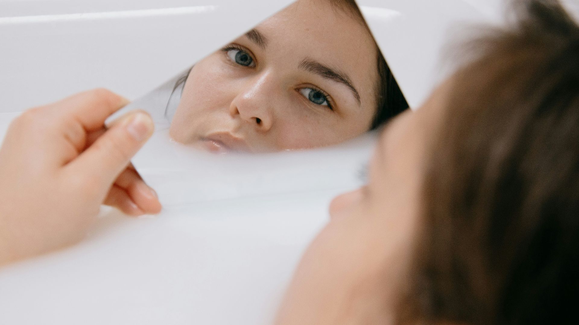 girl lying on white bathtub