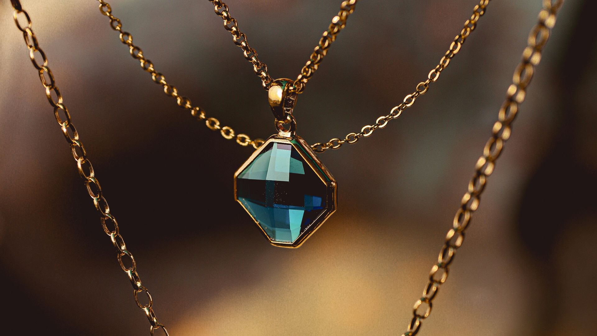 silver chain necklace with blue gemstone pendant