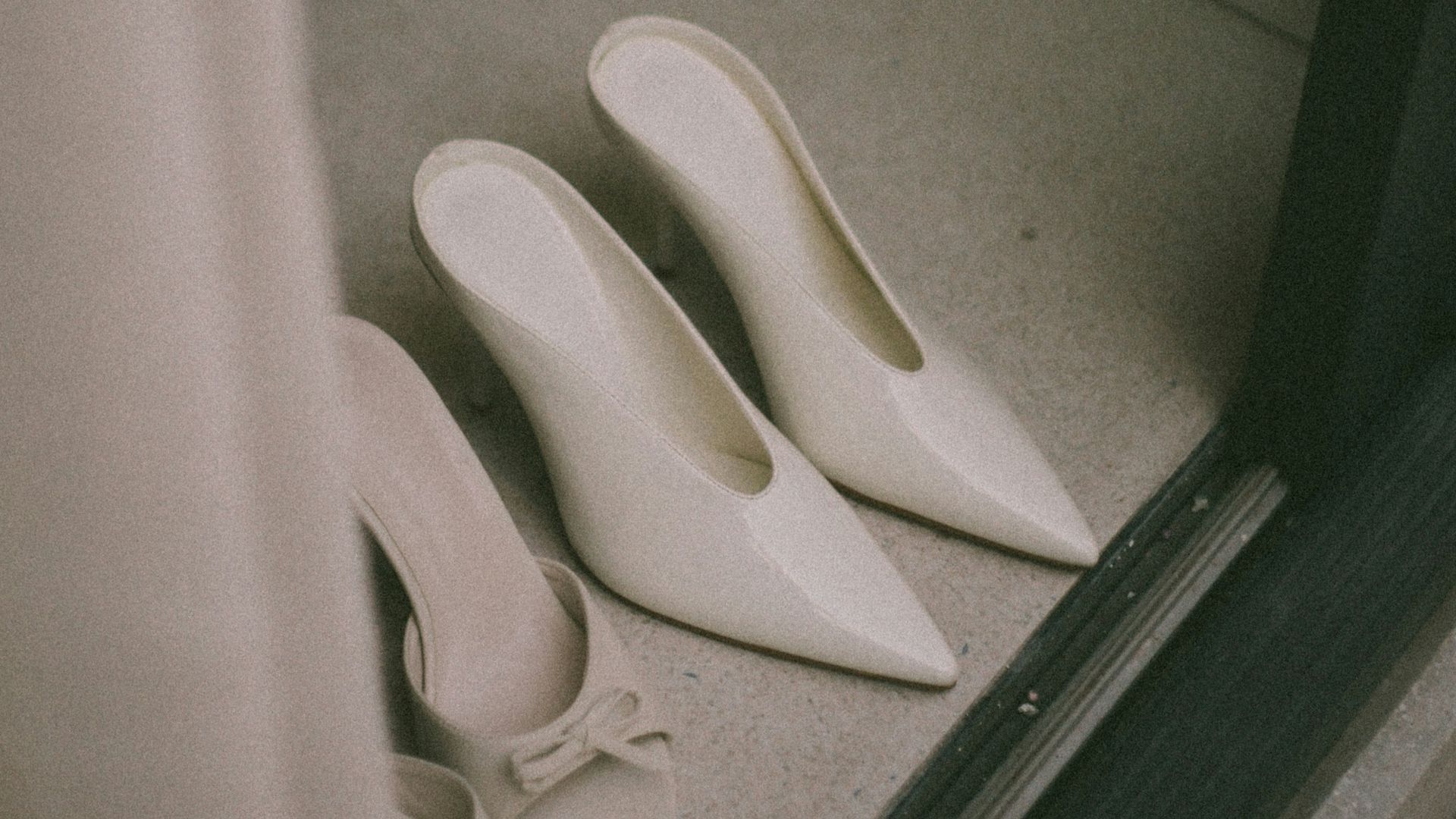 Pair of elegant white high heels on floor