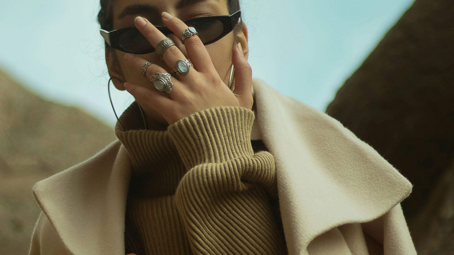 man in brown coat wearing black sunglasses