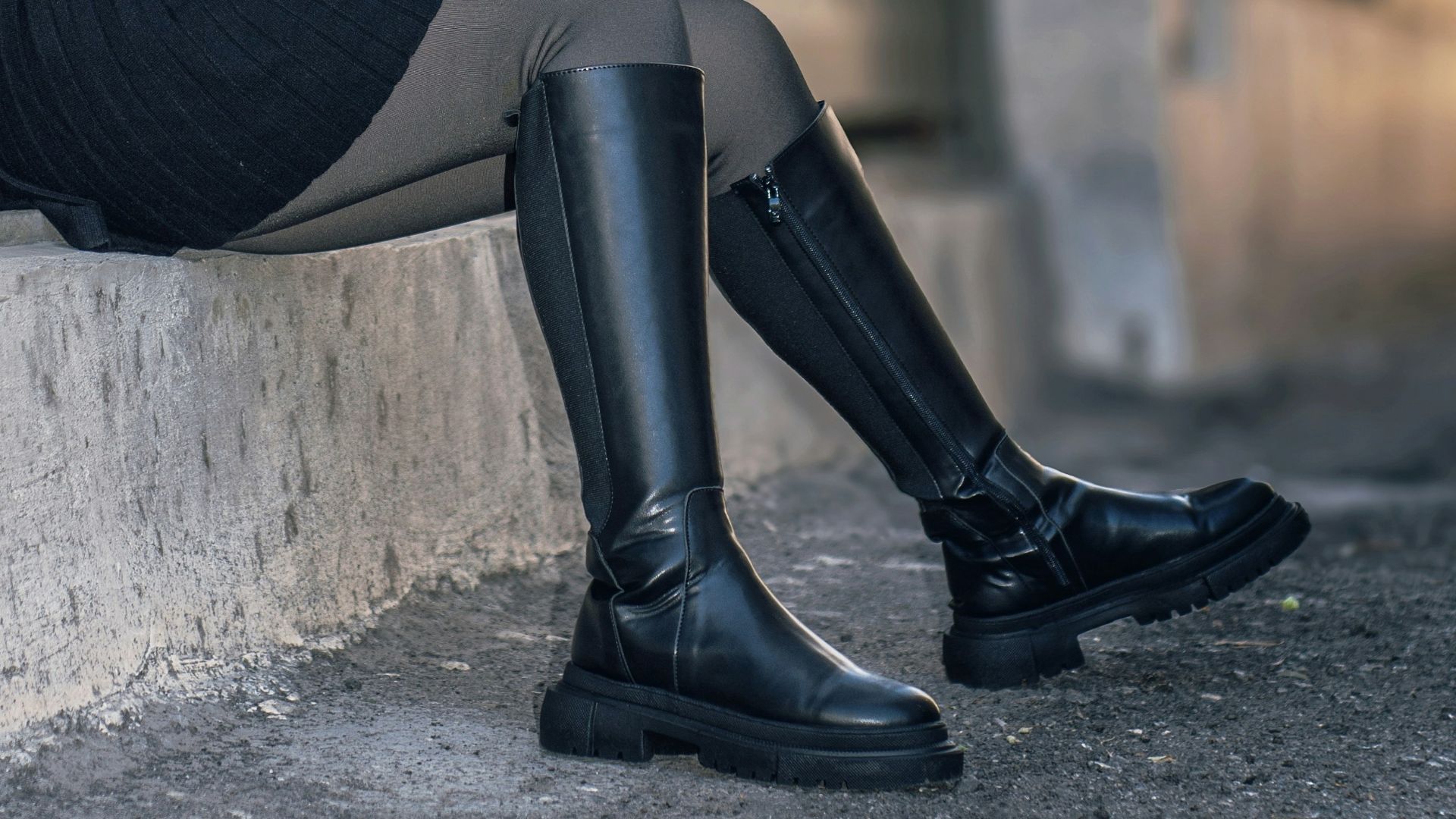 Woman with curly grey hair sitting by a doorway