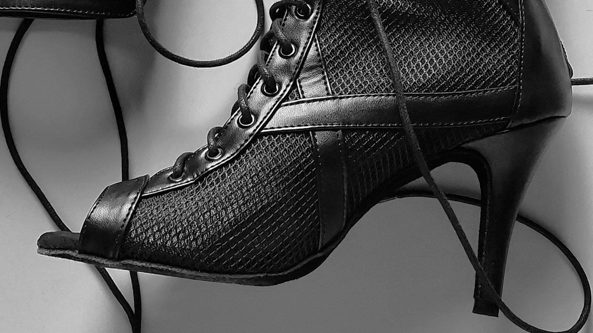 a pair of black boots sitting on top of a table