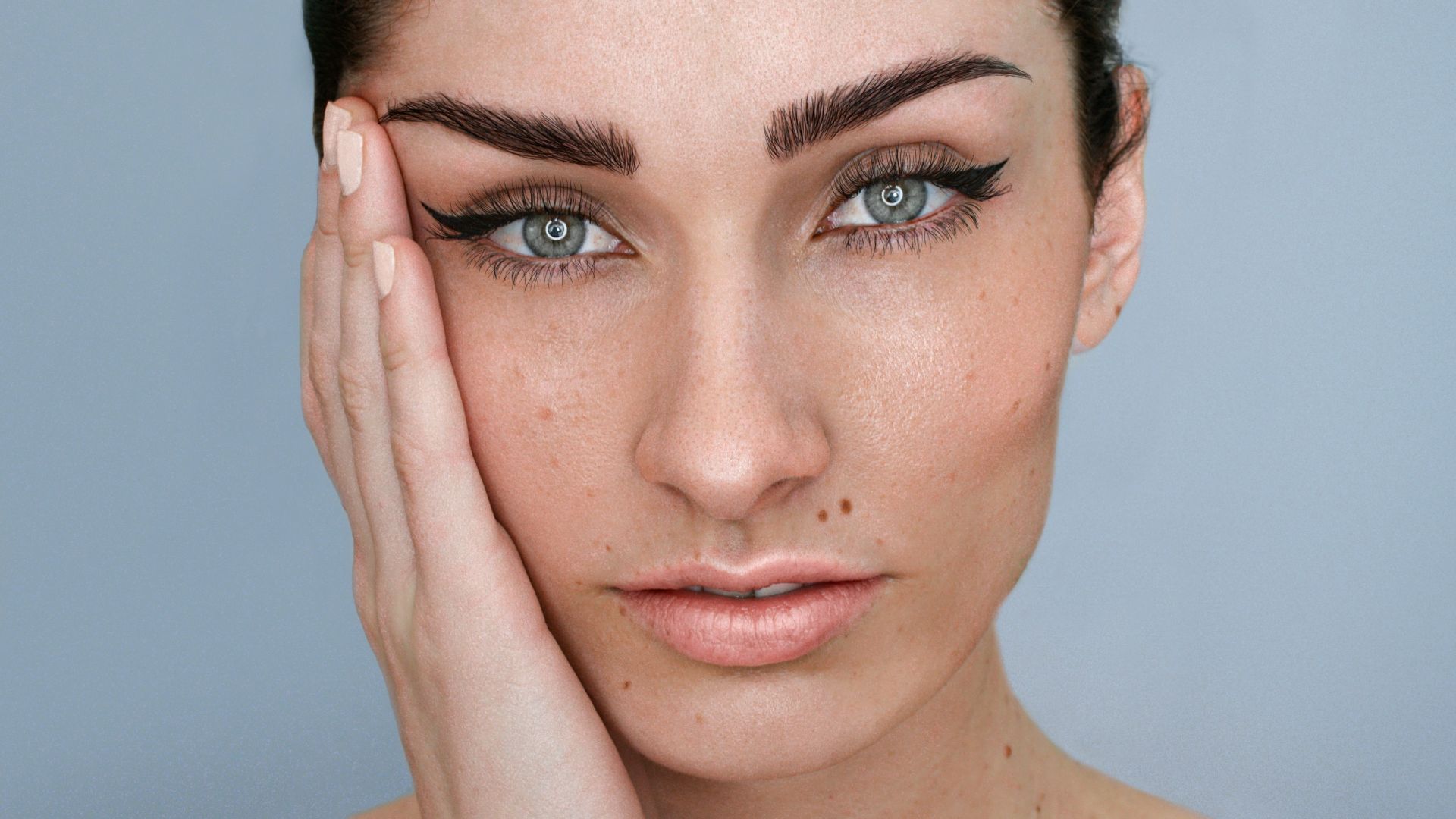 a woman with her hand on her face