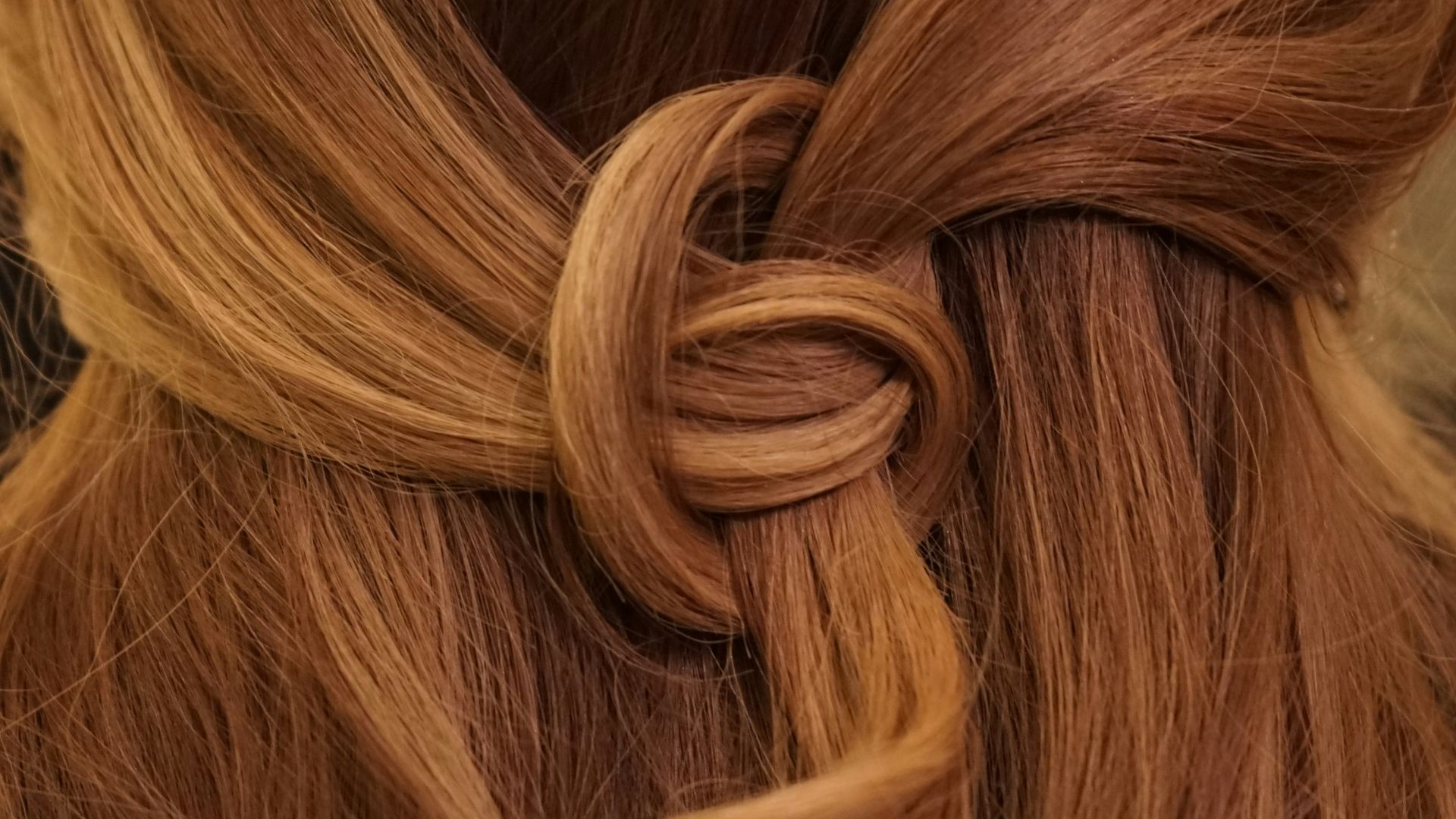 brown hair on white textile