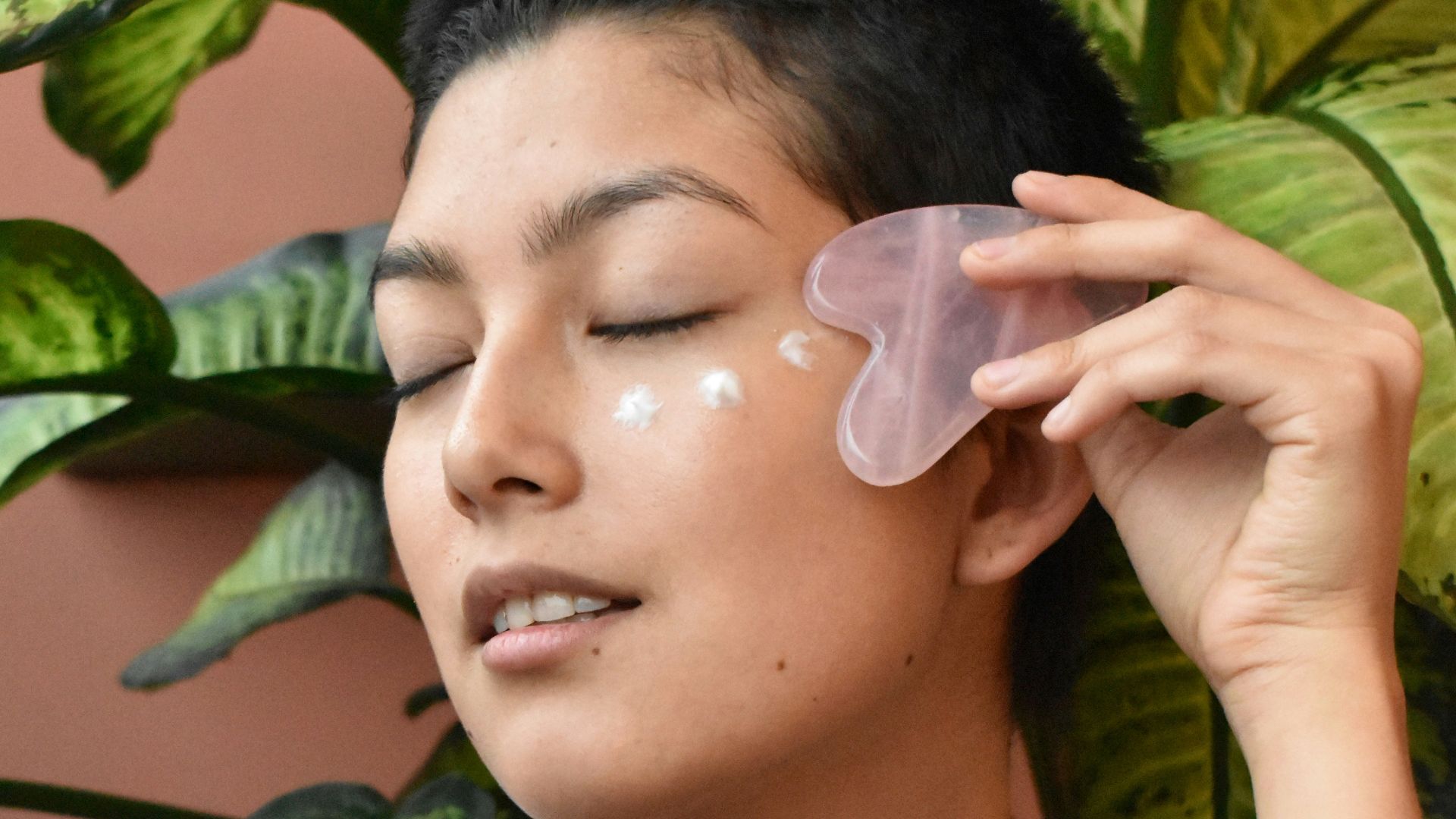 a woman holding a green object in her hand