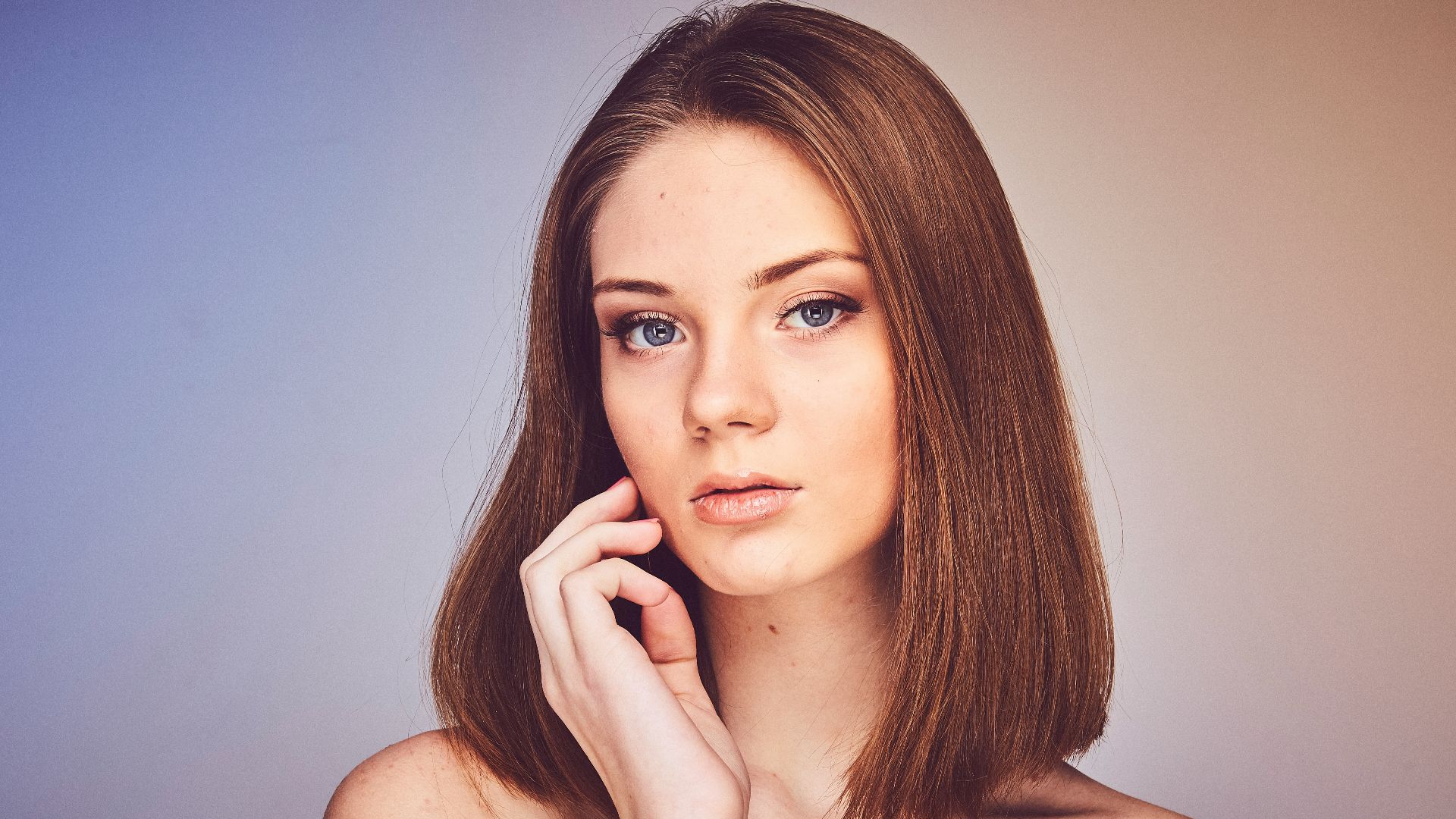 woman with her hand on cheek