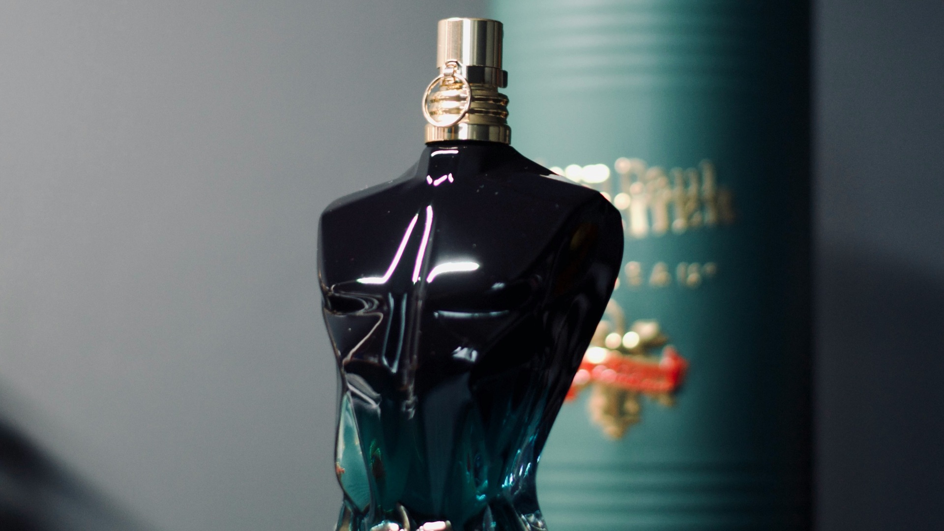 a bottle of perfume sitting next to a can