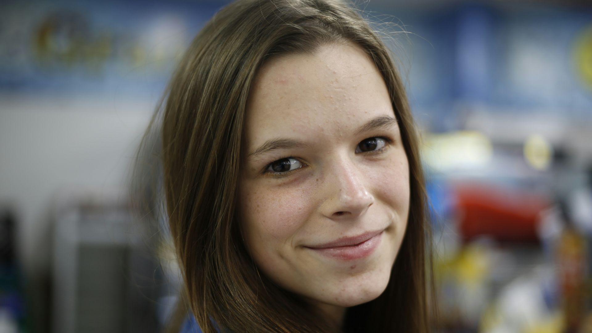 woman in blue crew neck shirt smiling