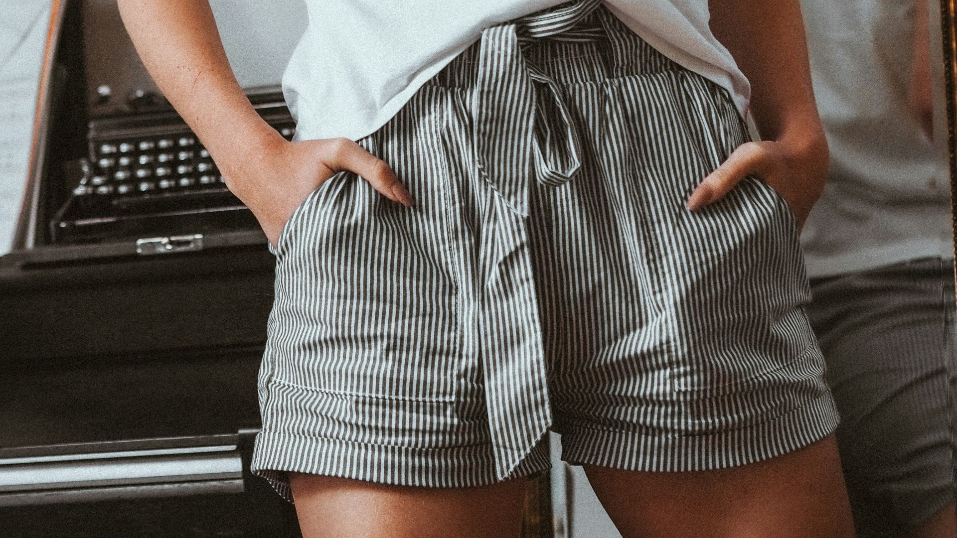 woman in white crew neck t-shirt and black and white striped skirt