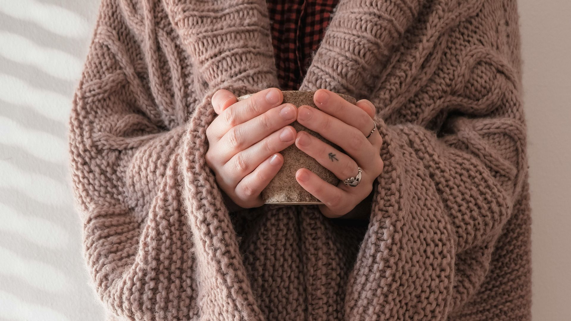 person in brown knit sweater