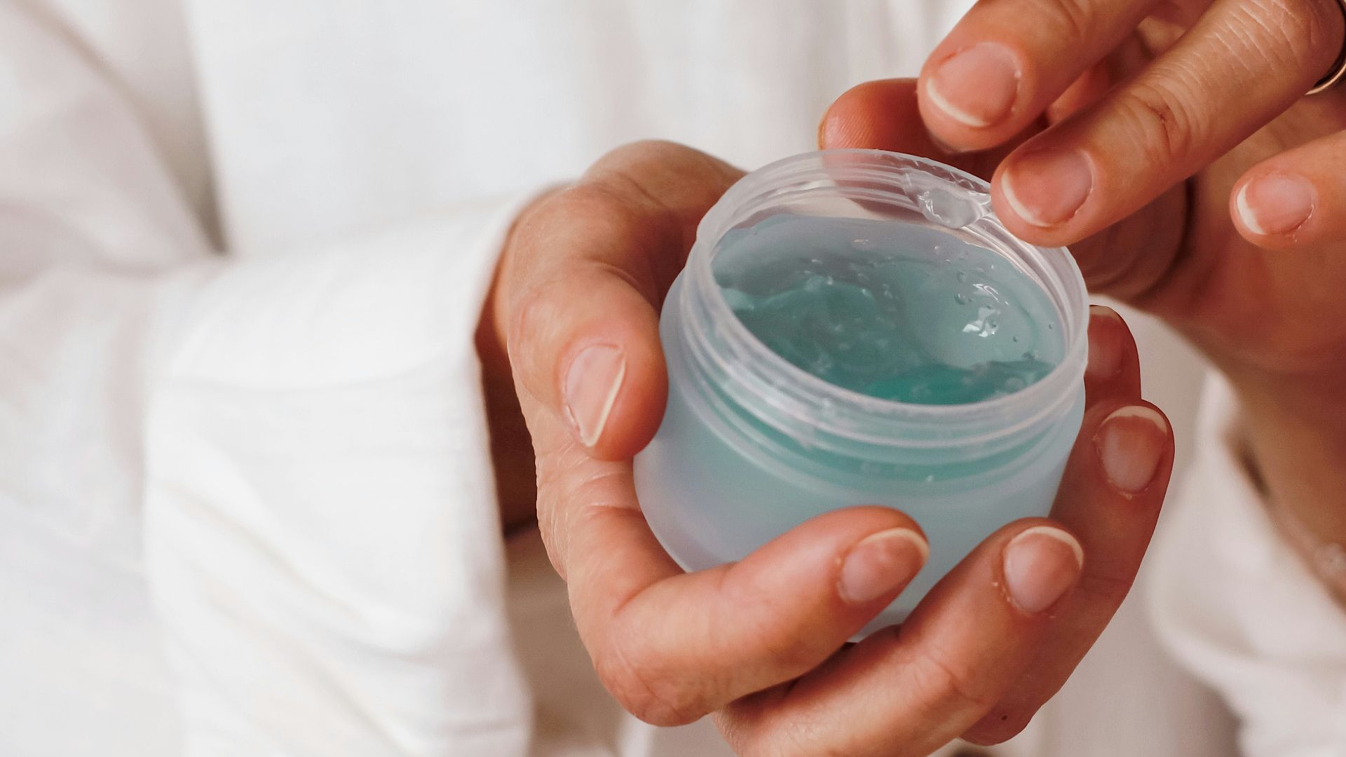 person holding blue plastic container