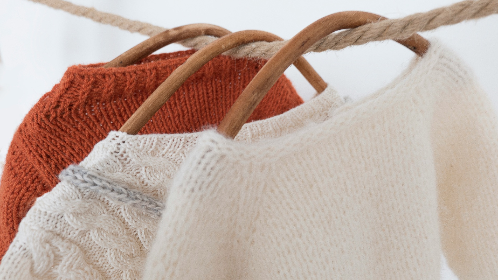 a couple of sweaters hanging on a clothes line