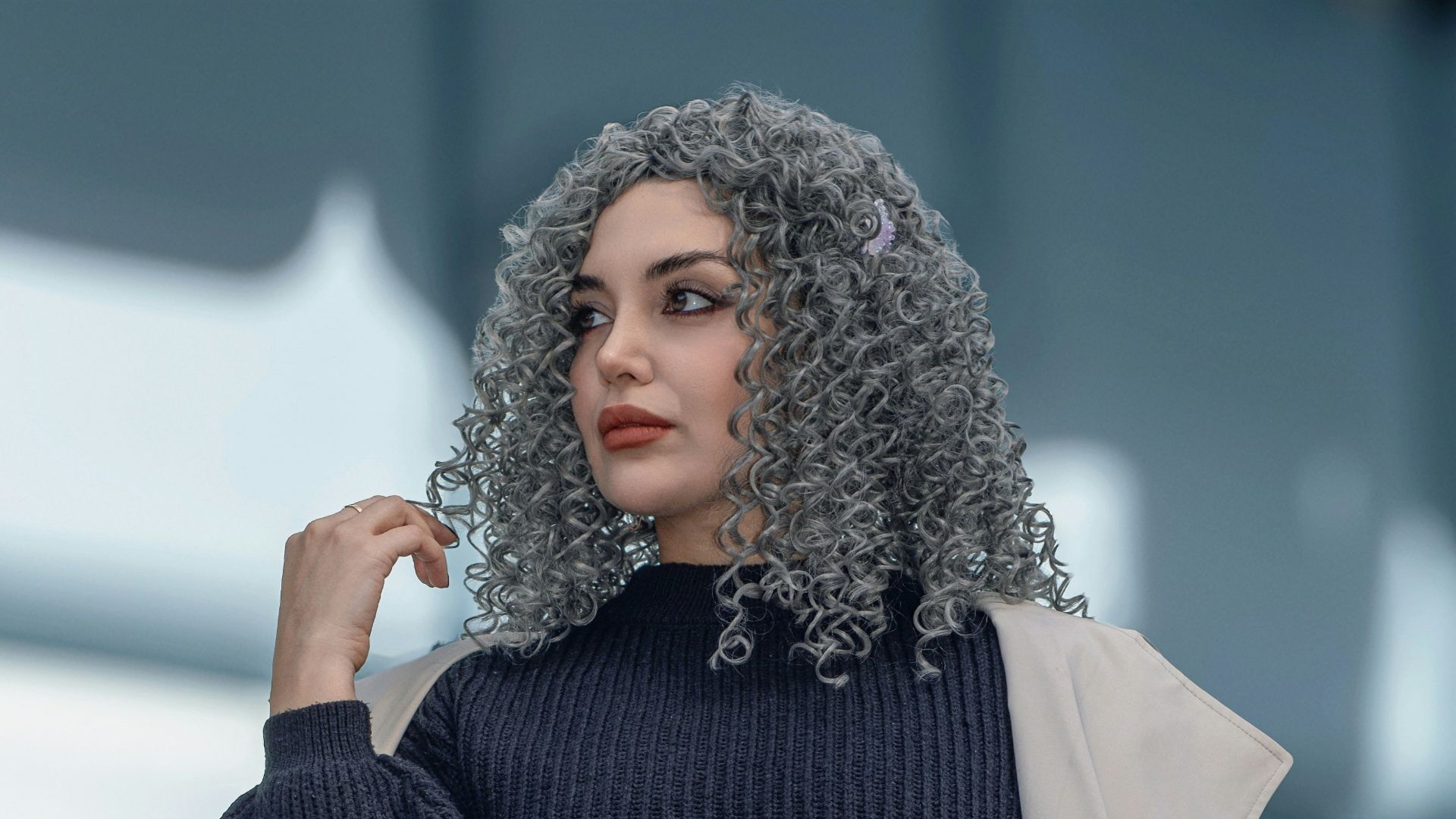 Woman with curly gray hair holding coffee cup