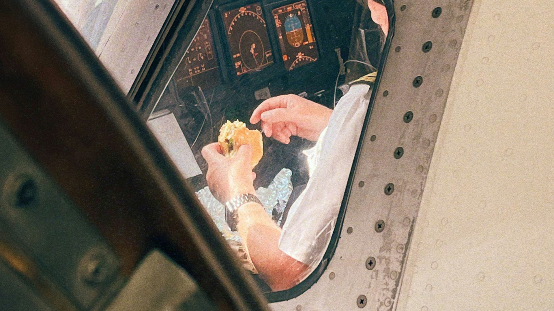 Pilot eating a sandwich in the cockpit