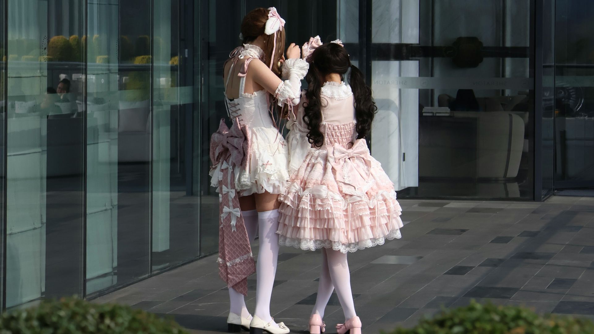 Two girls pose in lolita fashion.