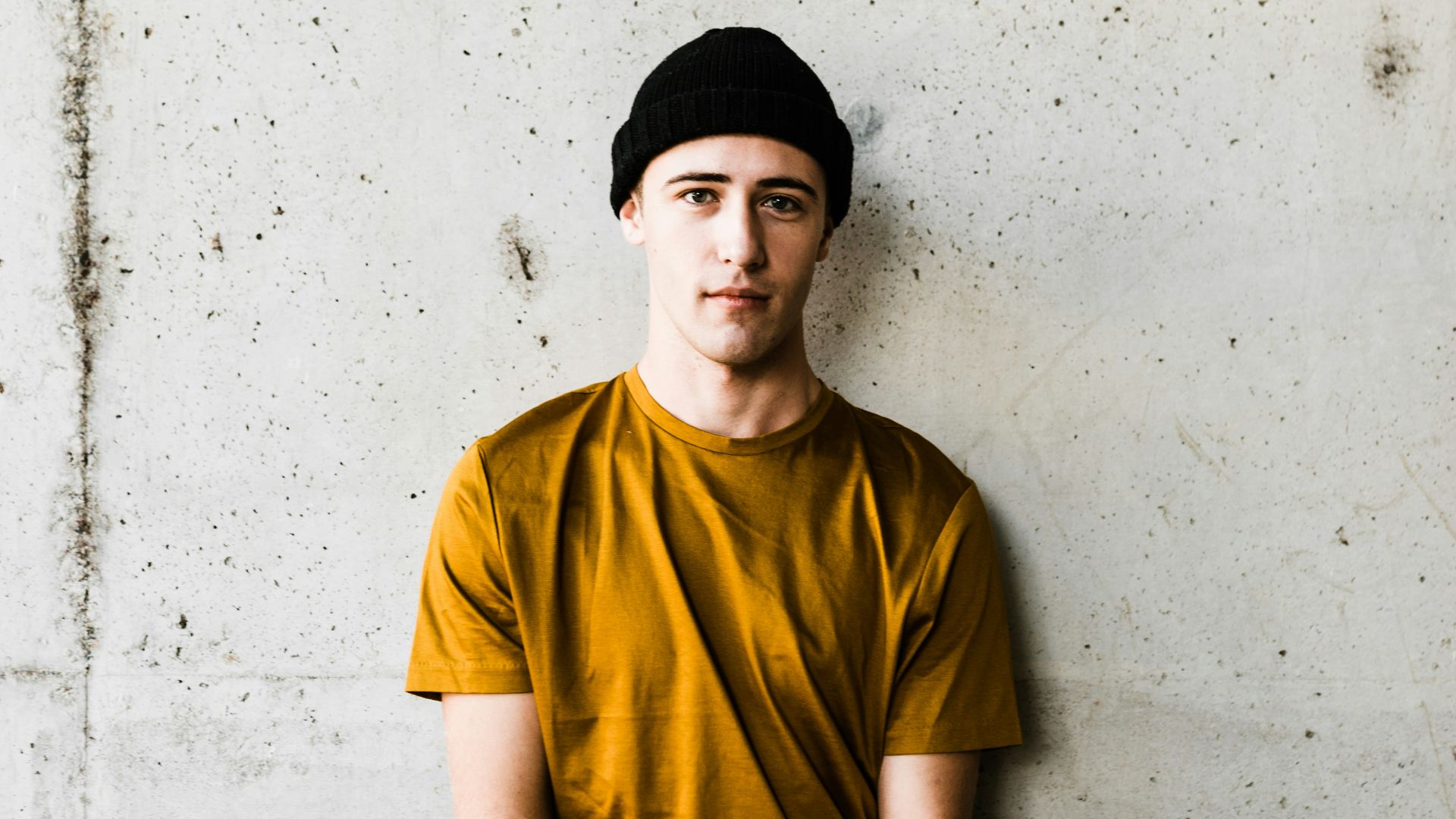 man standing while holding his hand