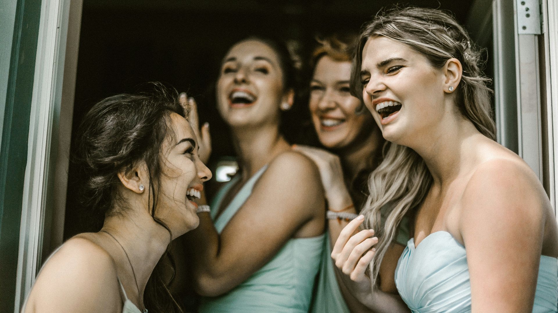woman wearing teal tube dress while smiling