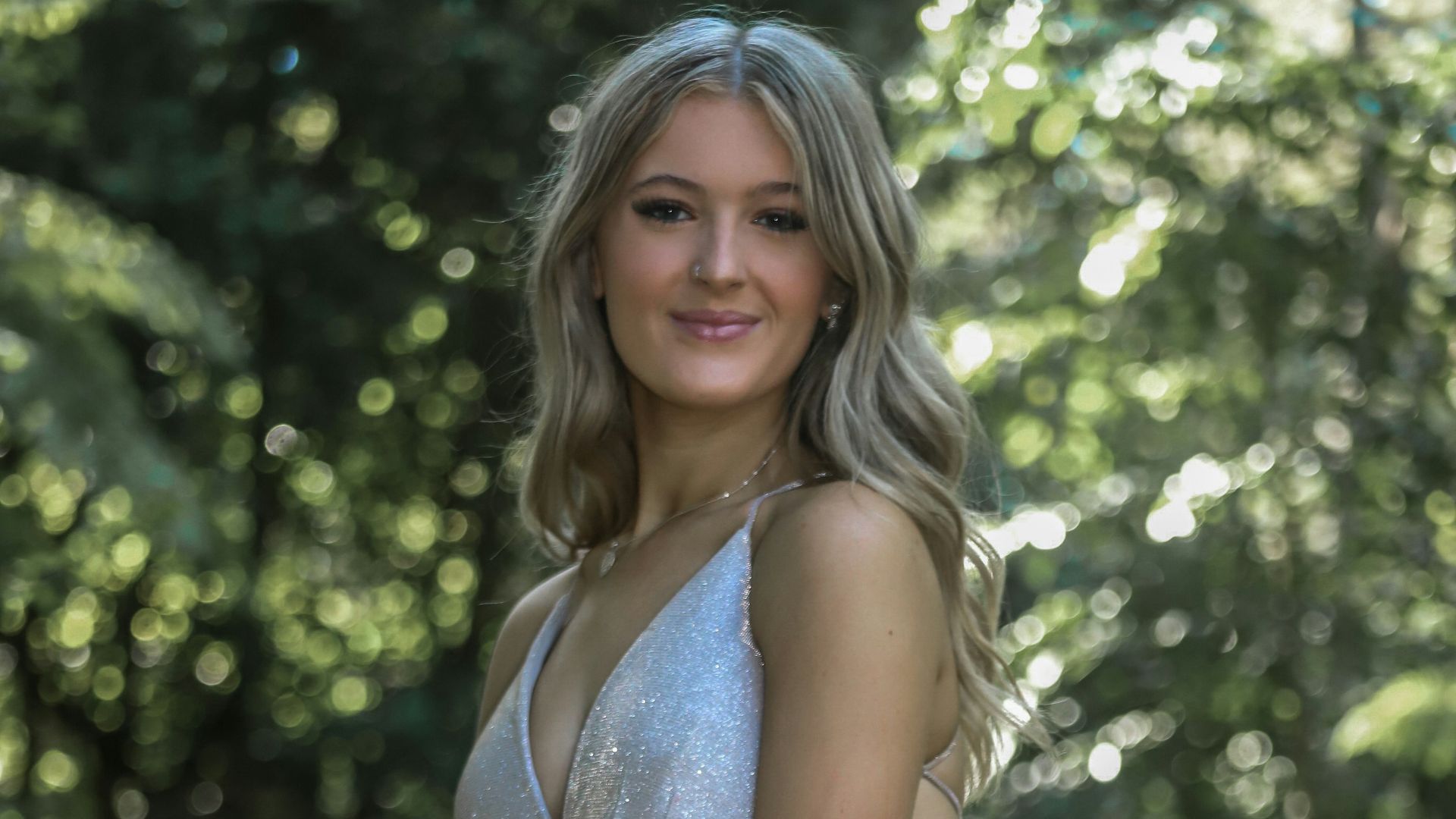 a woman in a silver dress posing for a picture