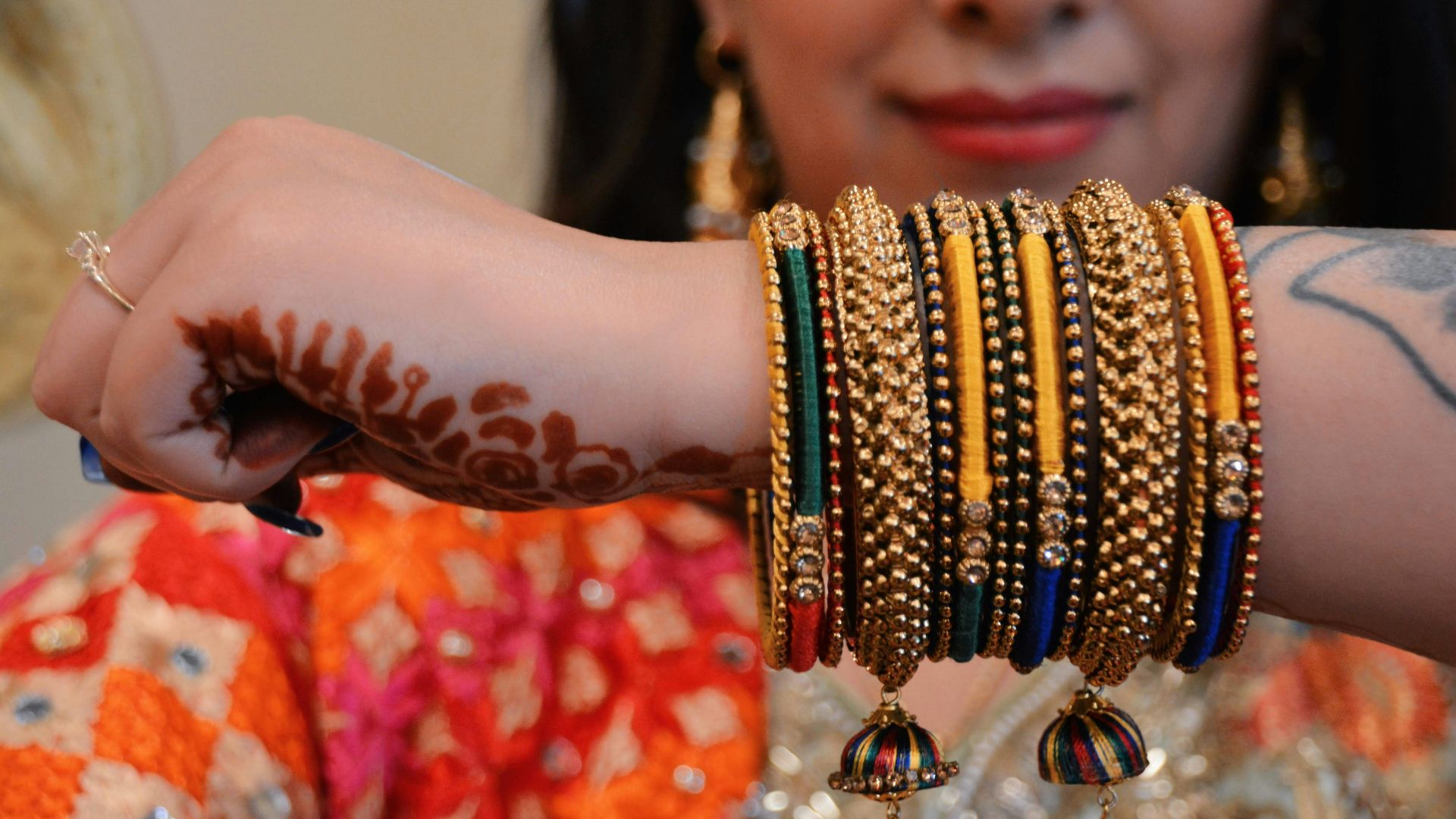 A woman with a bunch of bracelets on her arm