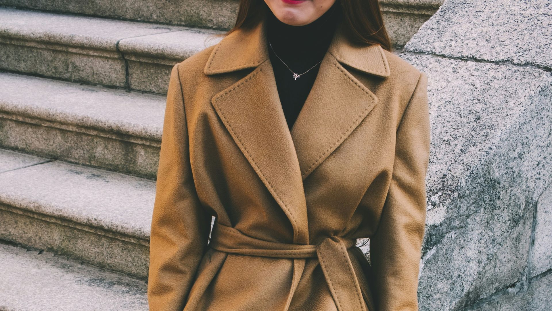 woman wearing brown notched lapel coat