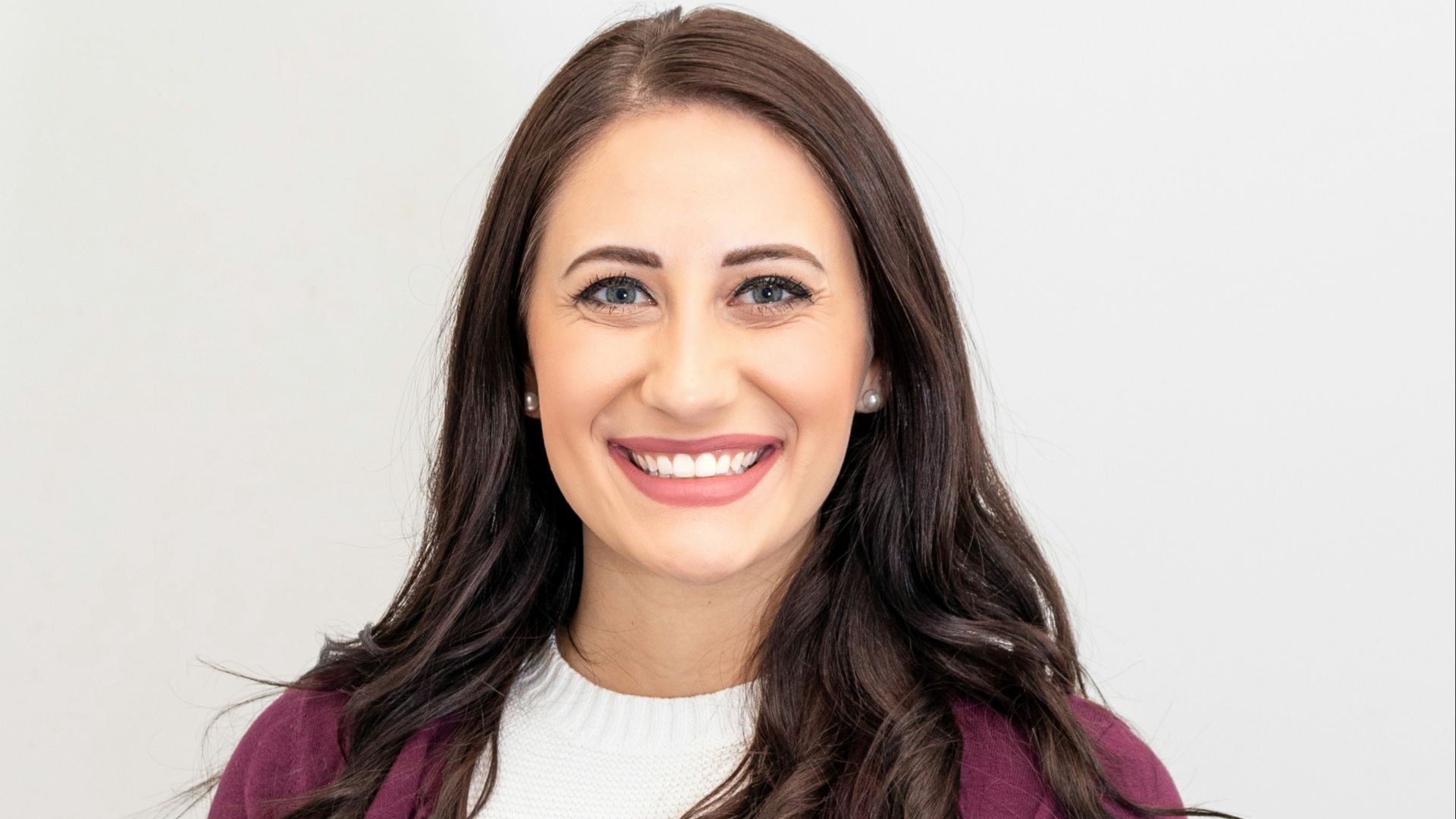 woman in red cardigan smiling
