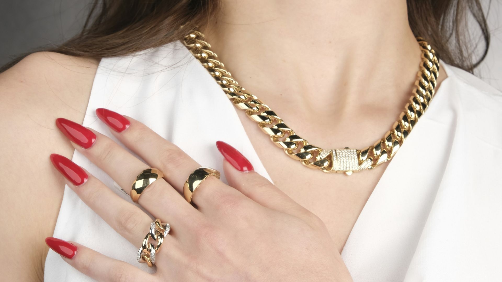 A woman in a white dress with red nails