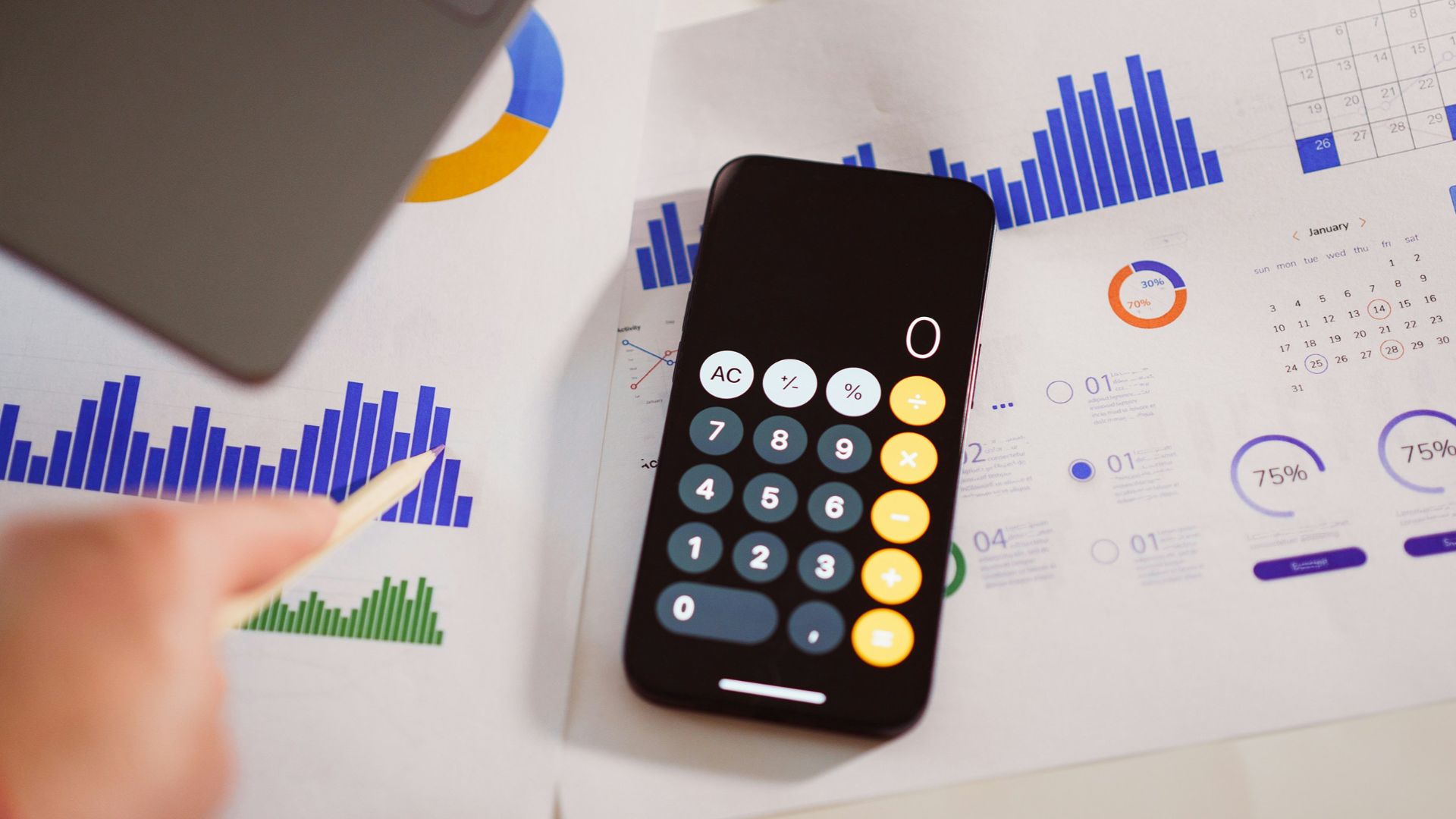 a calculator sitting on top of a table next to a laptop