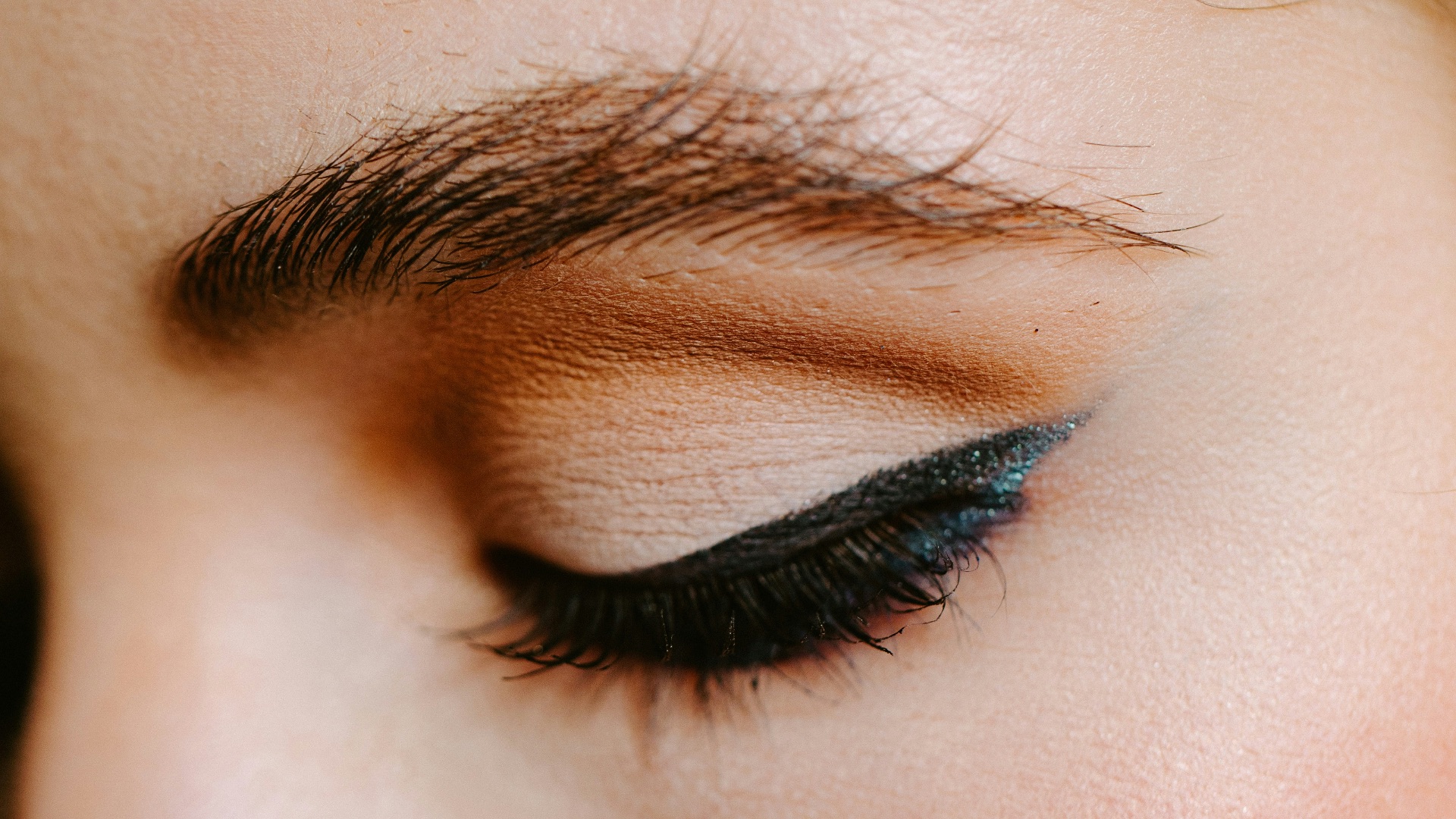 woman with red lipstick and black mascara