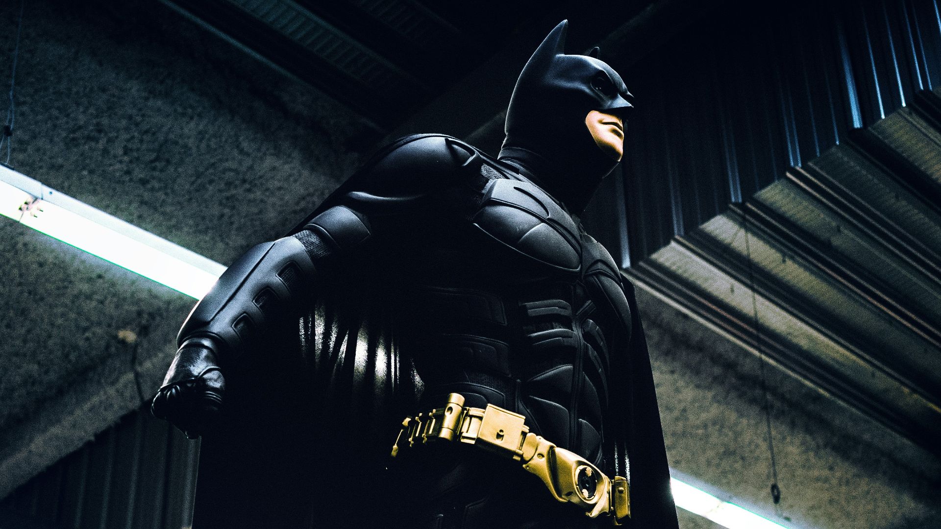 Batman standing under steel roof